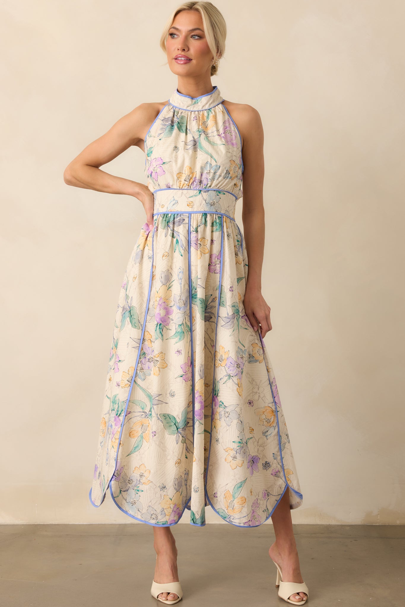 Full body front angle highlighting the panel skirt design, scalloped bottom hem, and how the floral pattern flows across the dress.
