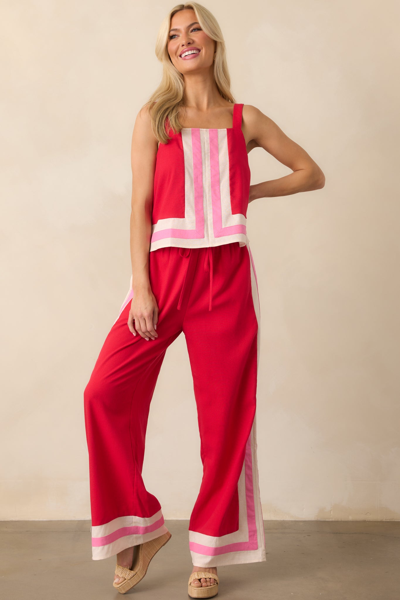 Front view of the red top showcasing the square neckline, relaxed fit, and vertical center seam with pink and ivory contrast trim.