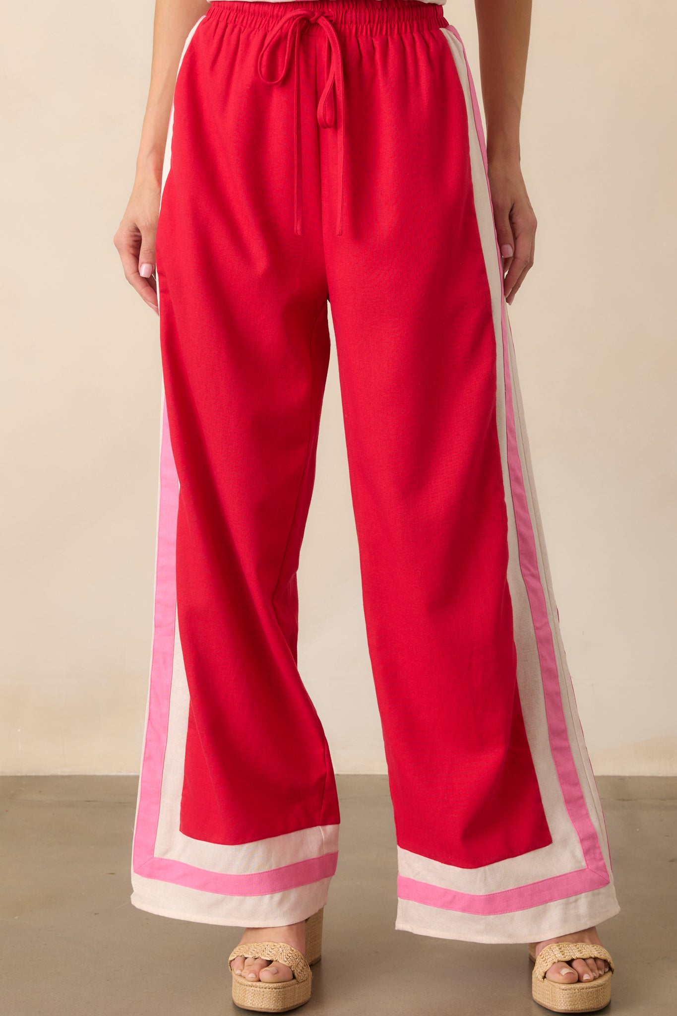 Close-up of the waistband area focusing on the elastic band, tied drawstring, and contrast trim detailing.