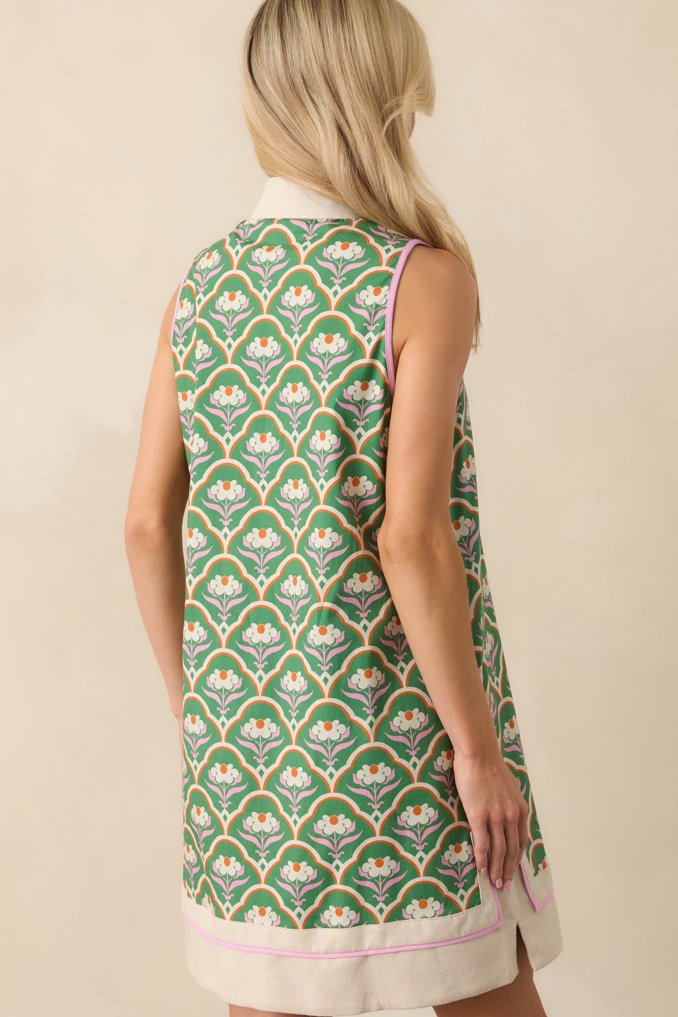 A view from behind showing the sleeveless cut, straight shift silhouette, and continuation of the geometric floral pattern.