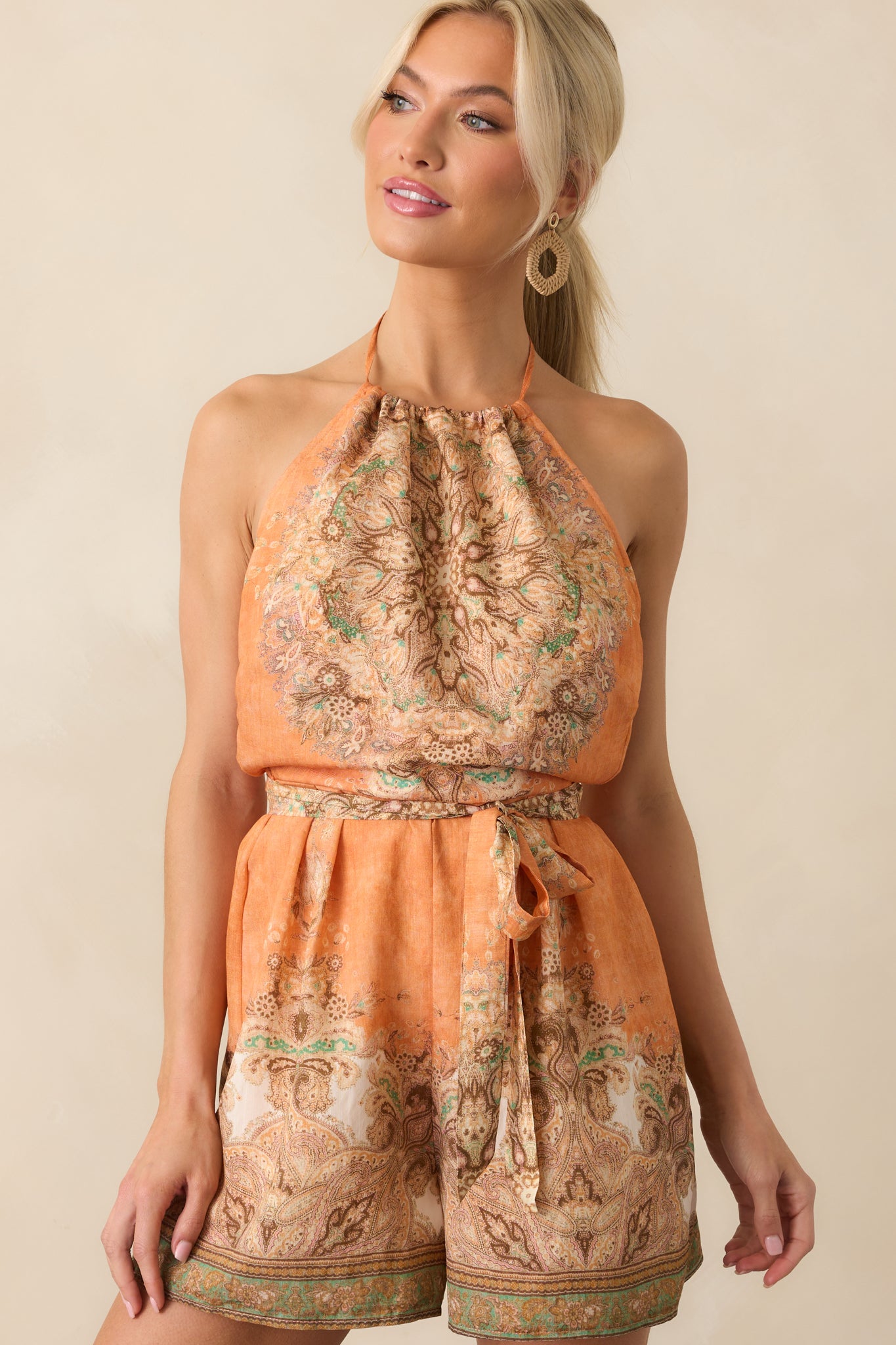 Cropped view of the halter neckline and upper bodice, showcasing the multicolor print and drawstring tie detail.