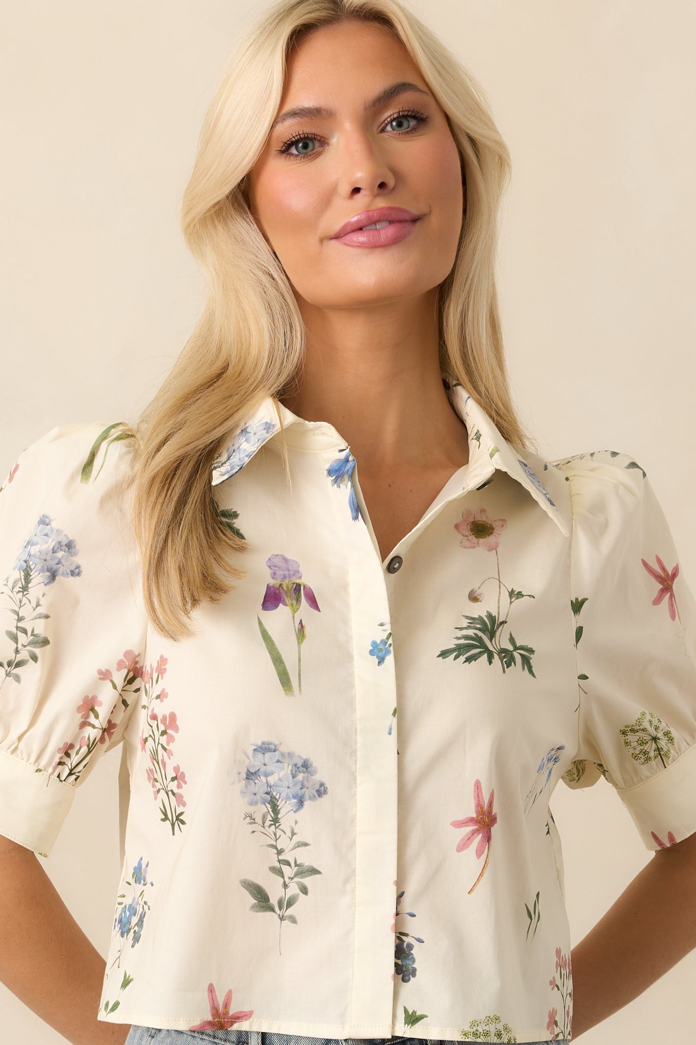 Cropped view focusing on the top’s multicolor floral print and the structure of the collared neckline.