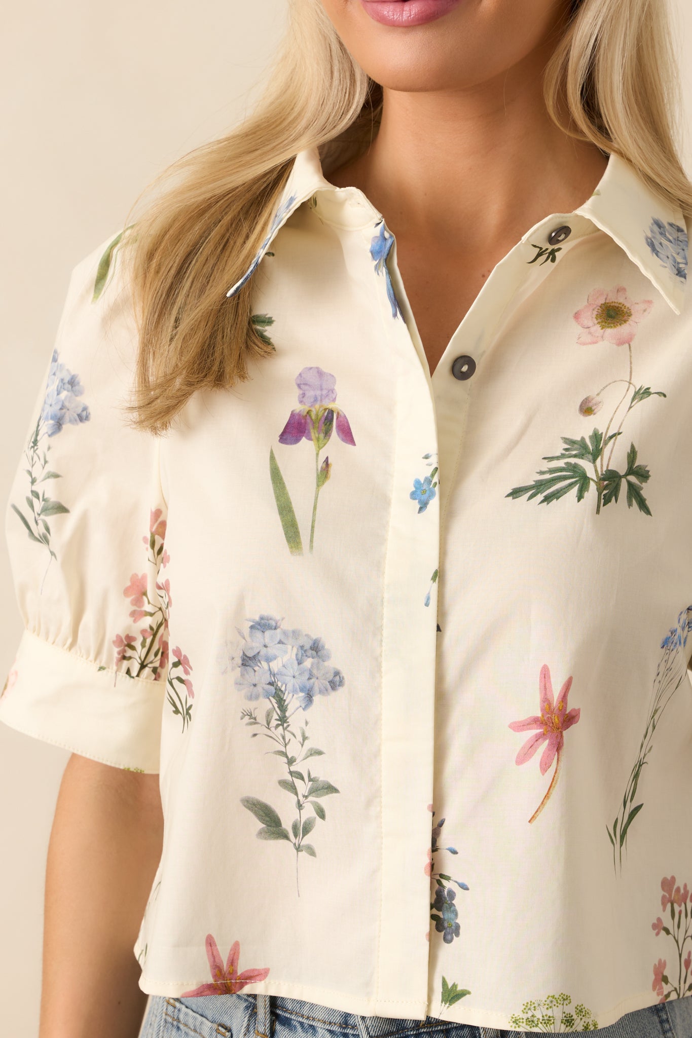 Detailed close-up of the floral pattern and fabric texture on the ivory top, highlighting the vibrant colors and print clarity.