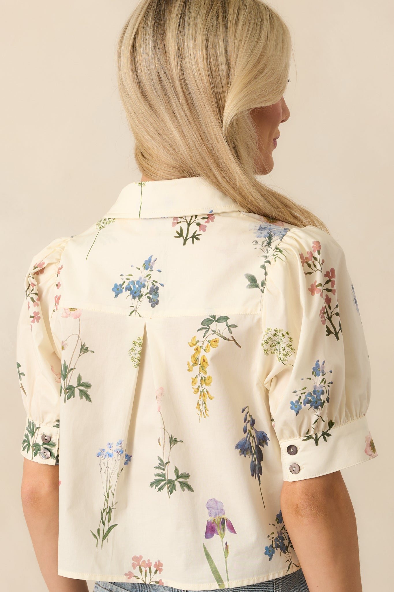 Back view of the top showing the floral pattern continuing throughout, with the relaxed fit and sleeve shape visible from behind.