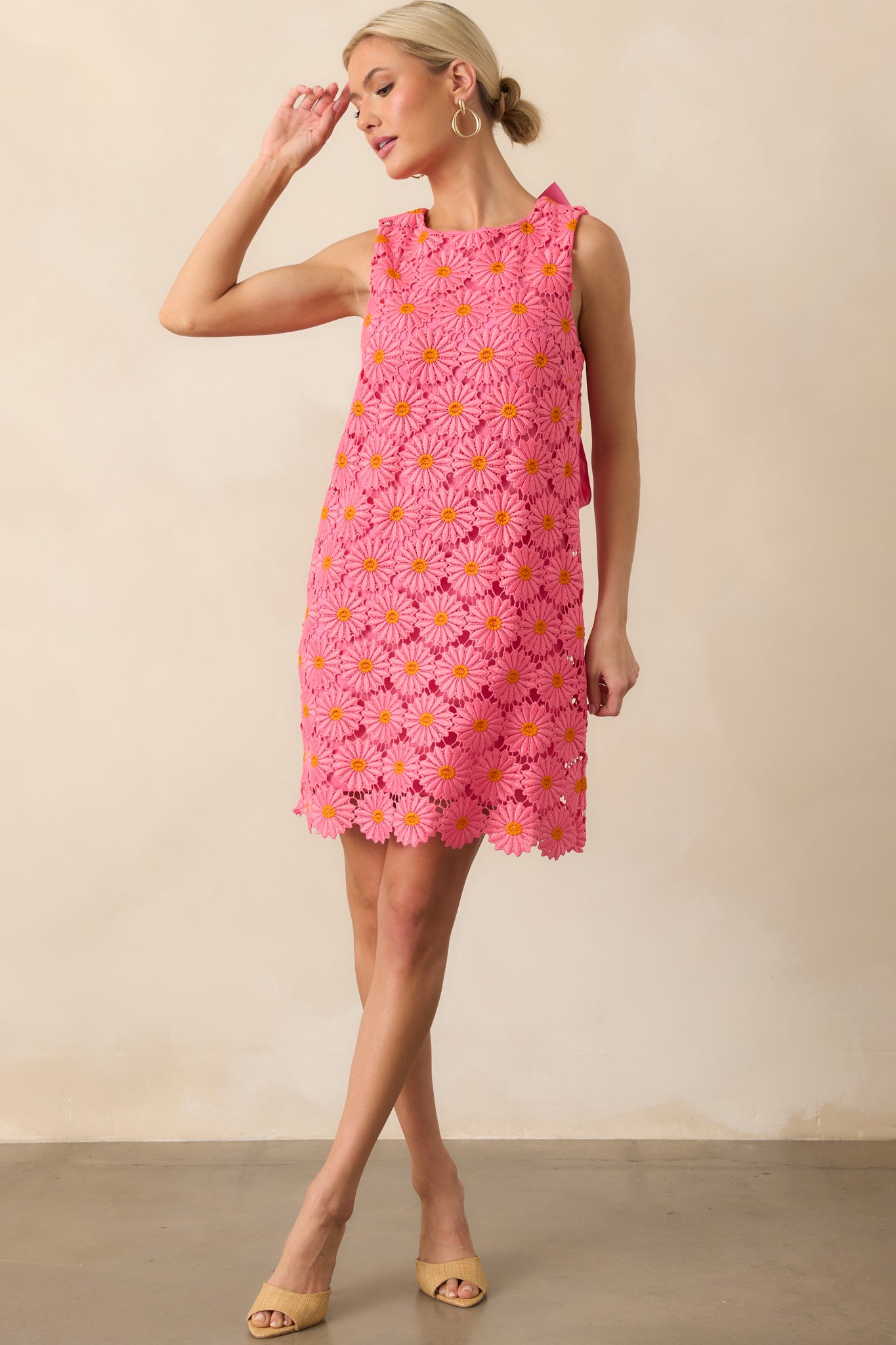 Full body view of the mini dress showing the hot pink and orange floral embroidered lace overlay and round neckline.