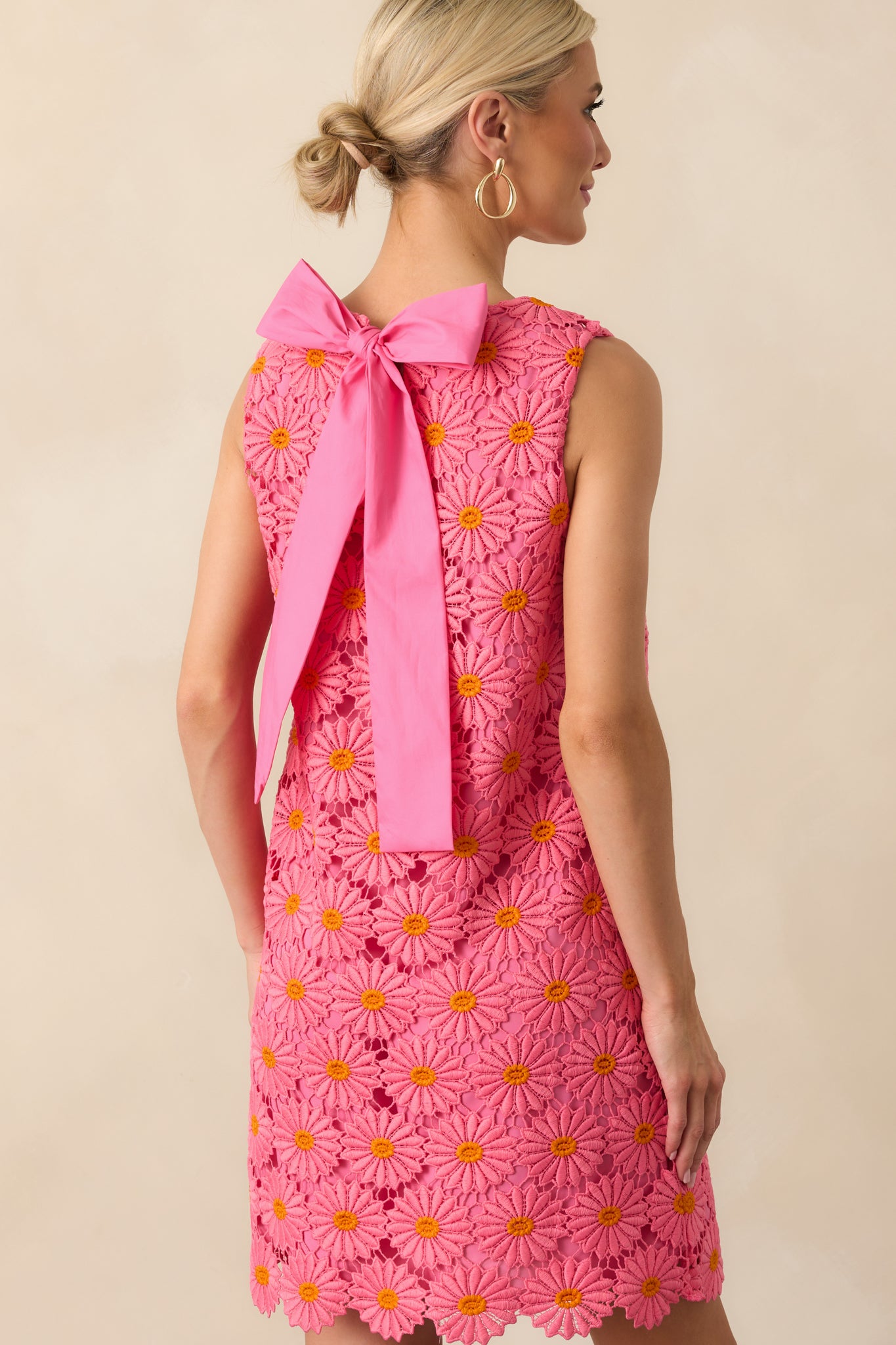 View from behind showing the keyhole bow back closure, scalloped hem, and lace overlay continuing throughout the back.