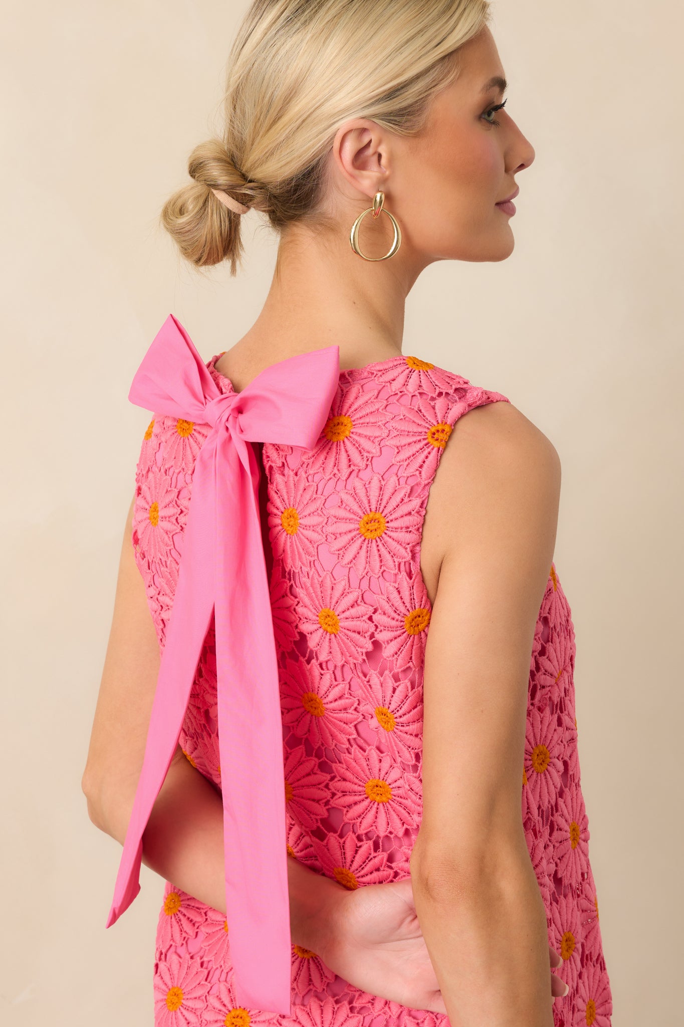 Close-up of the keyhole bow back closure and intricate floral embroidery.