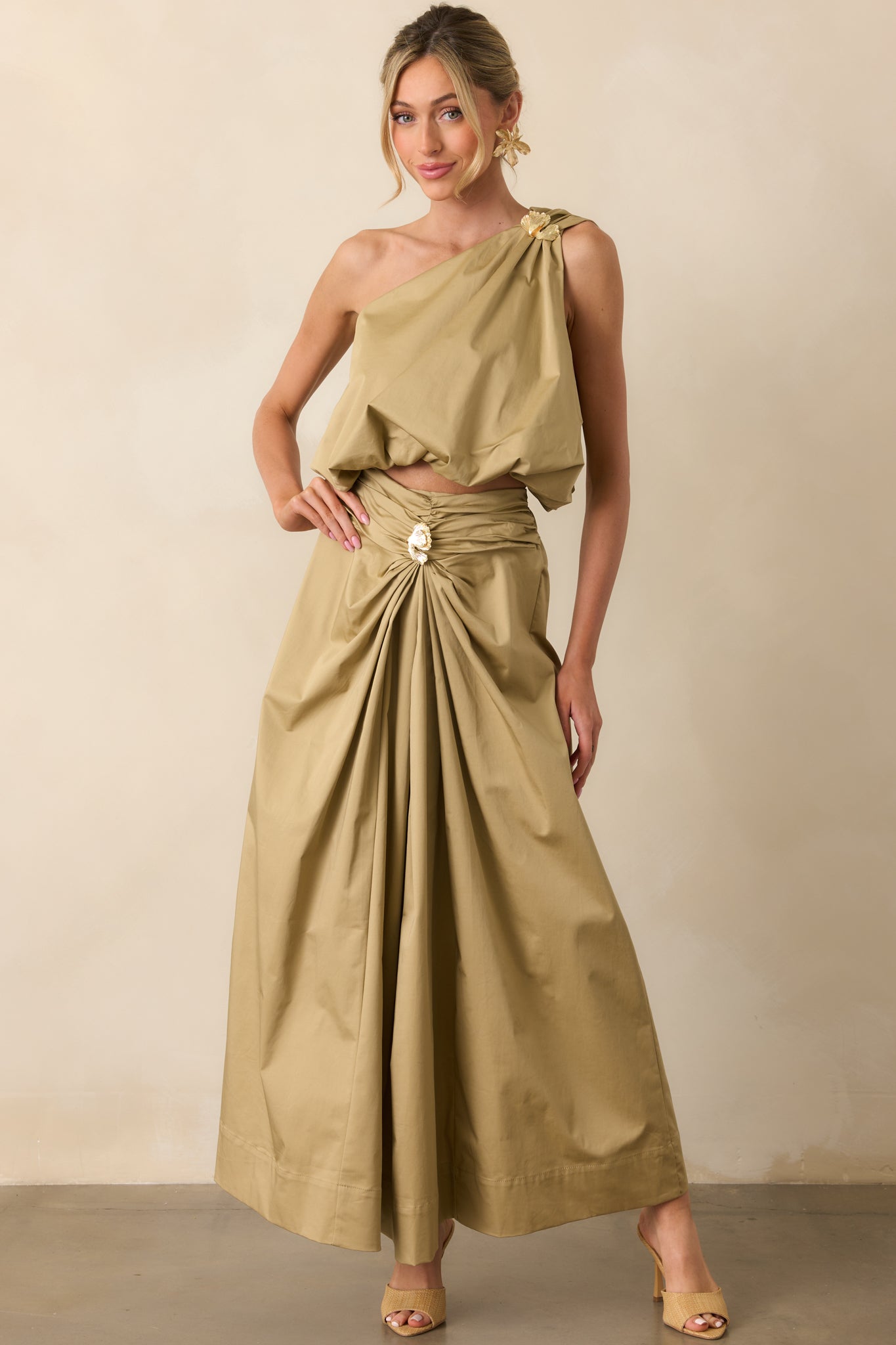 Full body front view showing the tan one shoulder top with a 3D textured gold embellishment and elastic bubble hem.
