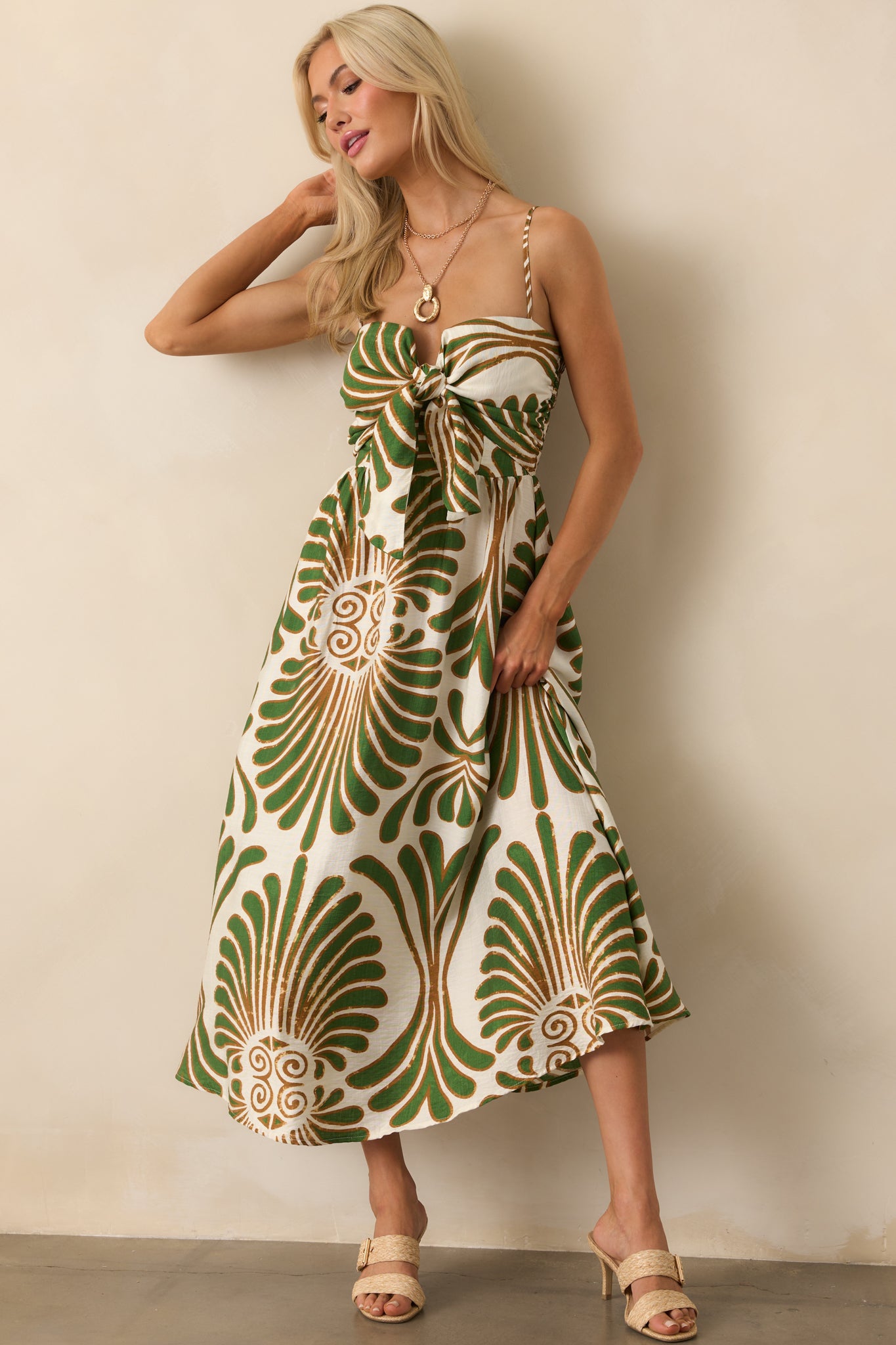 Full body straight-on shot emphasizing the front-tie detail and the contrast of green and bronze botanical patterns.