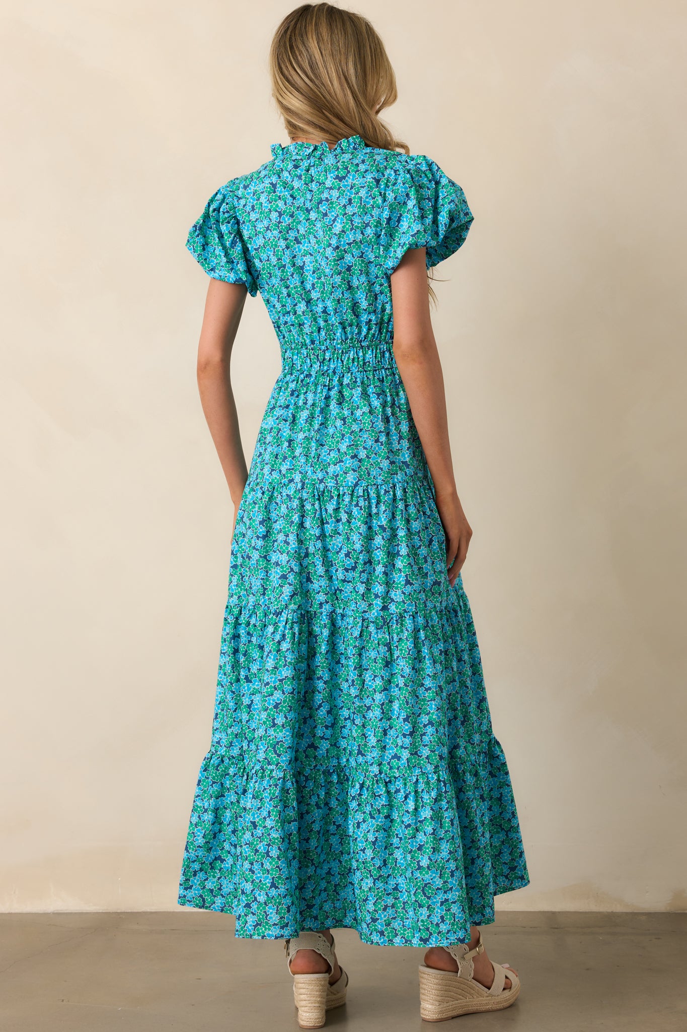 A view from behind displaying the tiered construction and how the floral print continues across the back of the dress.