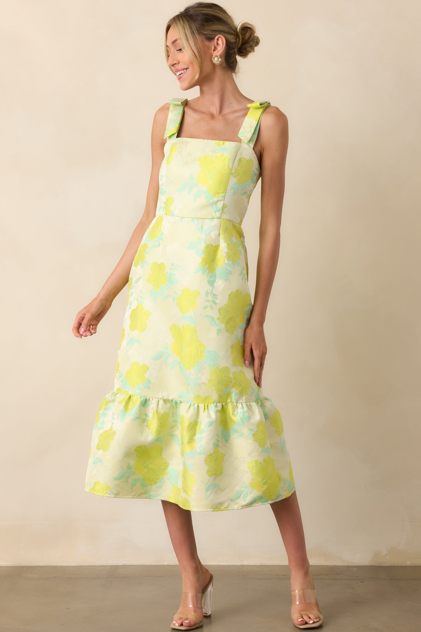 Front-facing full body image showcasing the textured floral jacquard fabric and the flow of the bottom tiered skirt.