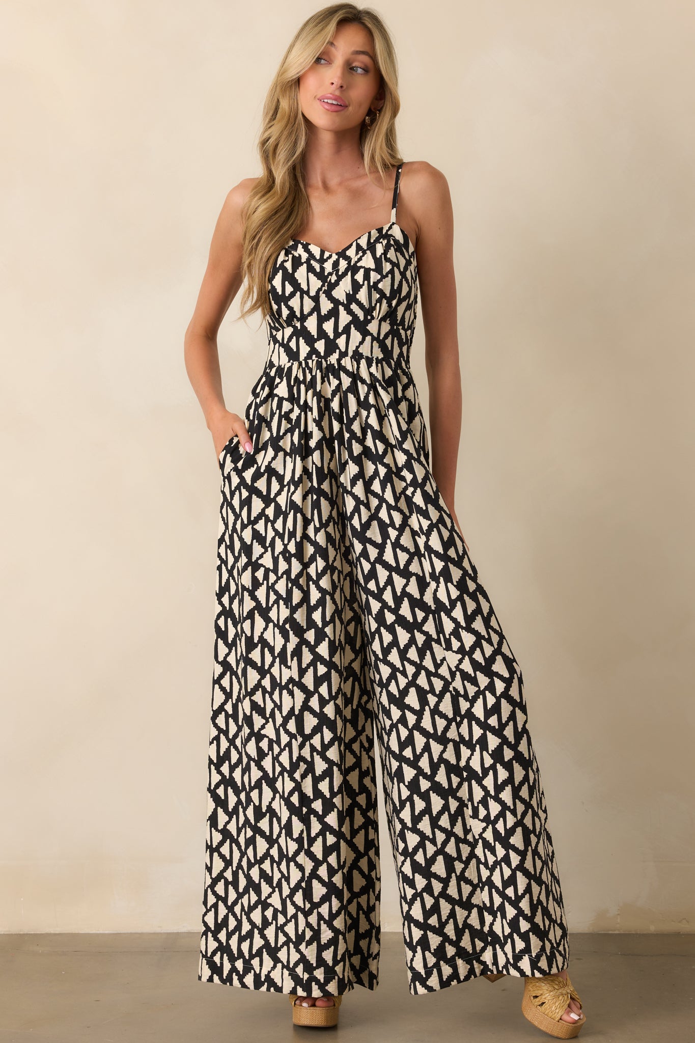 A head-to-toe image displaying the relaxed silhouette and flowy pant legs of the jumpsuit.