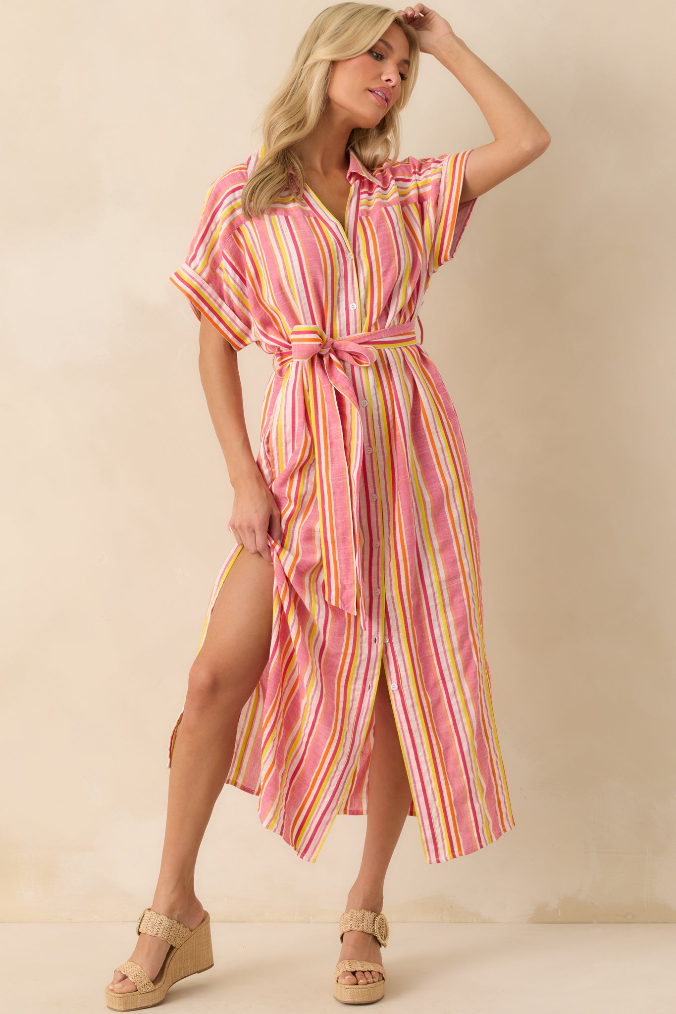 Full body front view of the pink maxi dress featuring a multicolor stripe pattern, collared neckline, and button front design.