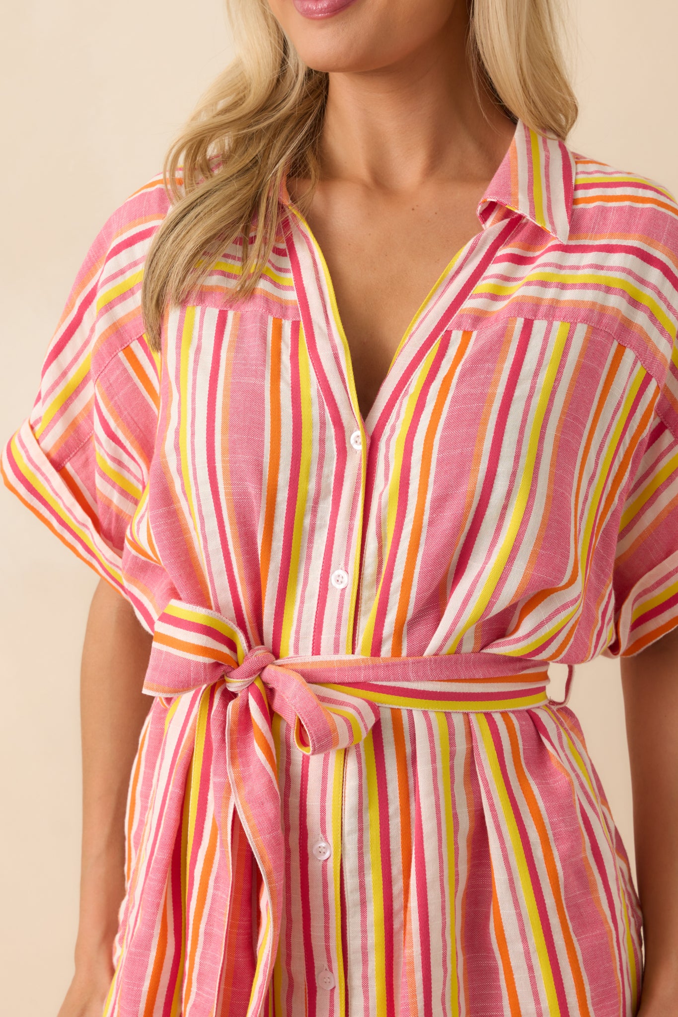 Close-up of the multicolor stripe fabric and button front, showing the texture of the material and stitching detail.