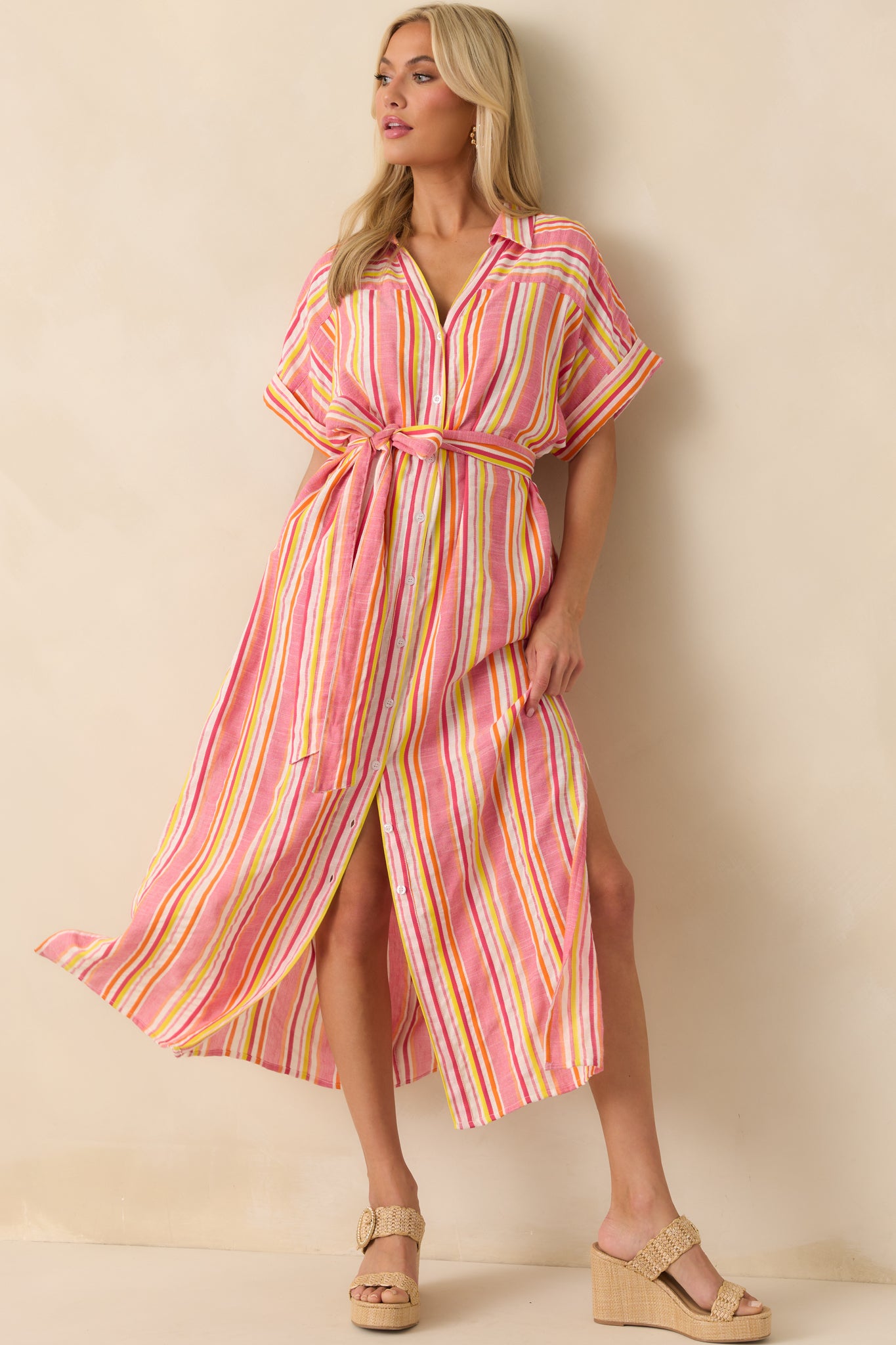 Full body image showcasing the cuffed short sleeves and side vent leg slits of the striped maxi dress.