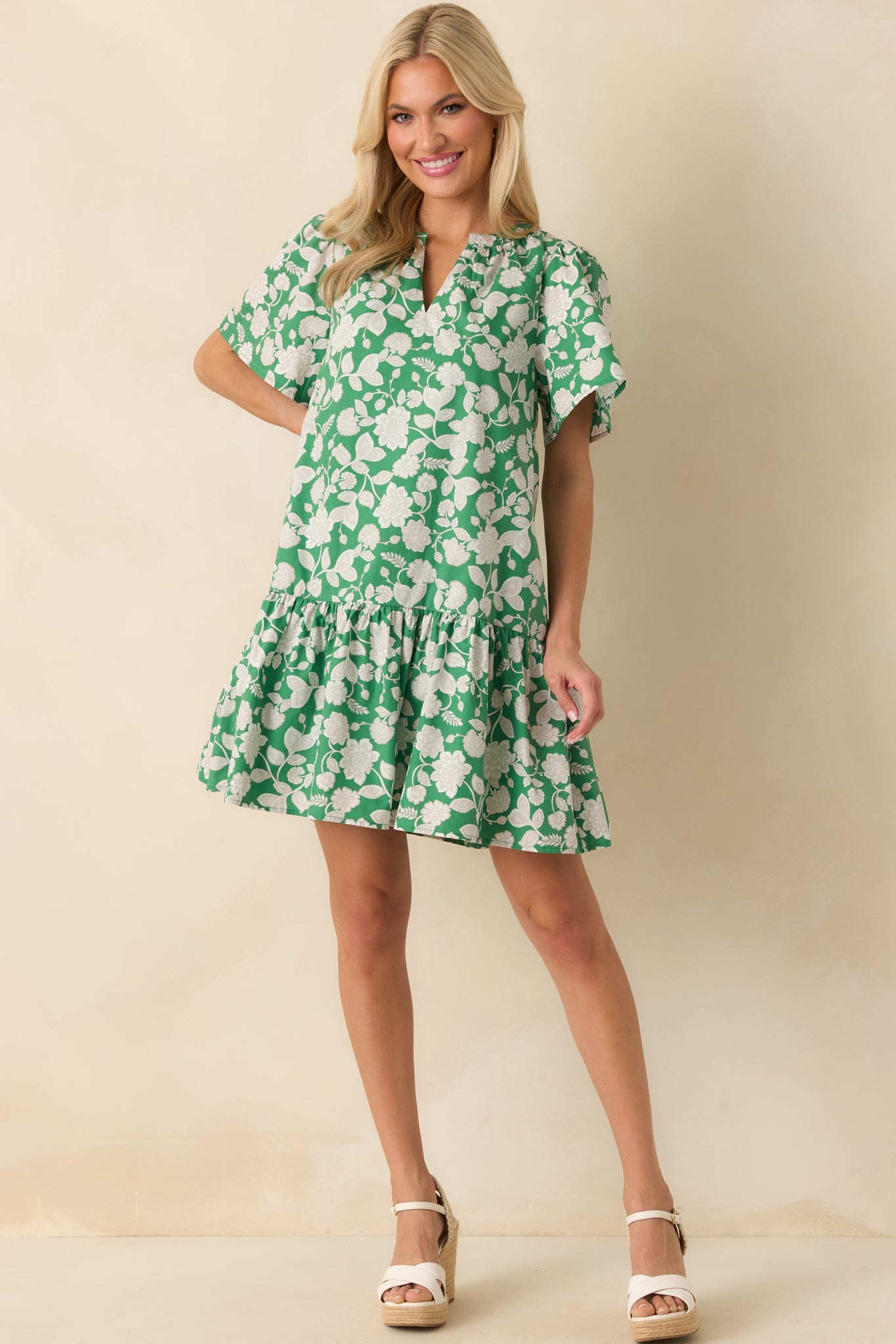Full body view of the green mini dress featuring a notch v-neckline, short sleeves, and a relaxed fit throughout.