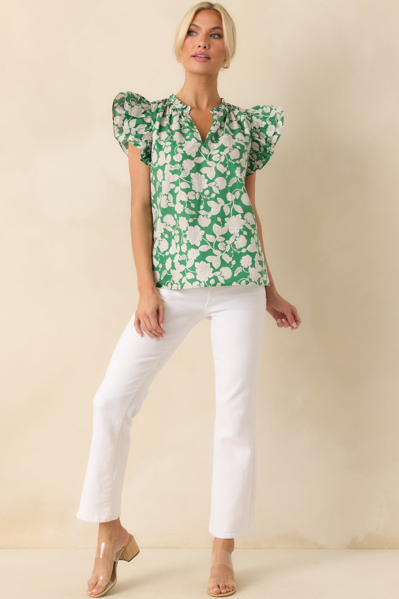 Full body view of the green top with an allover white and grey paisley floral print, shown with a relaxed fit silhouette.
