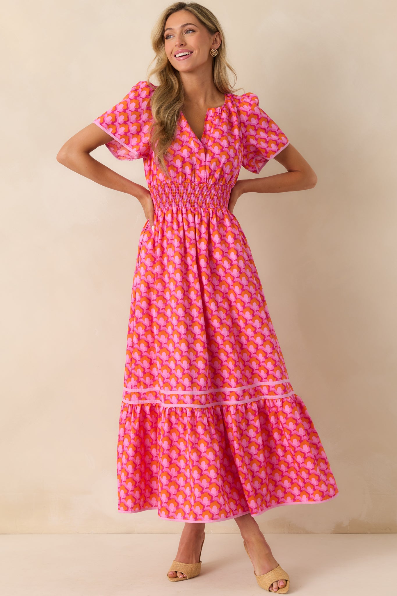 Full body image highlighting the short sleeves and fully smocked waist that creates a defined silhouette.