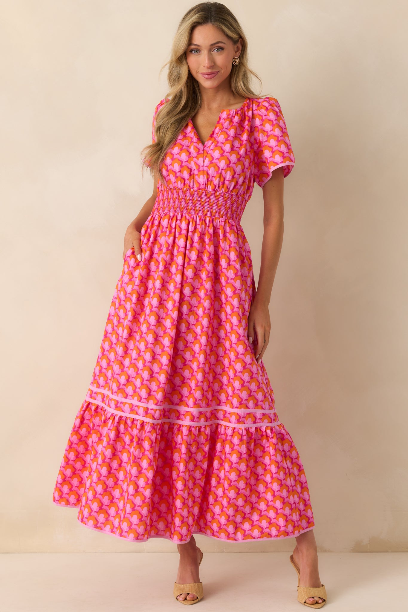 Front view capturing the flowing tiered skirt and light pink trim detailing along the hem.