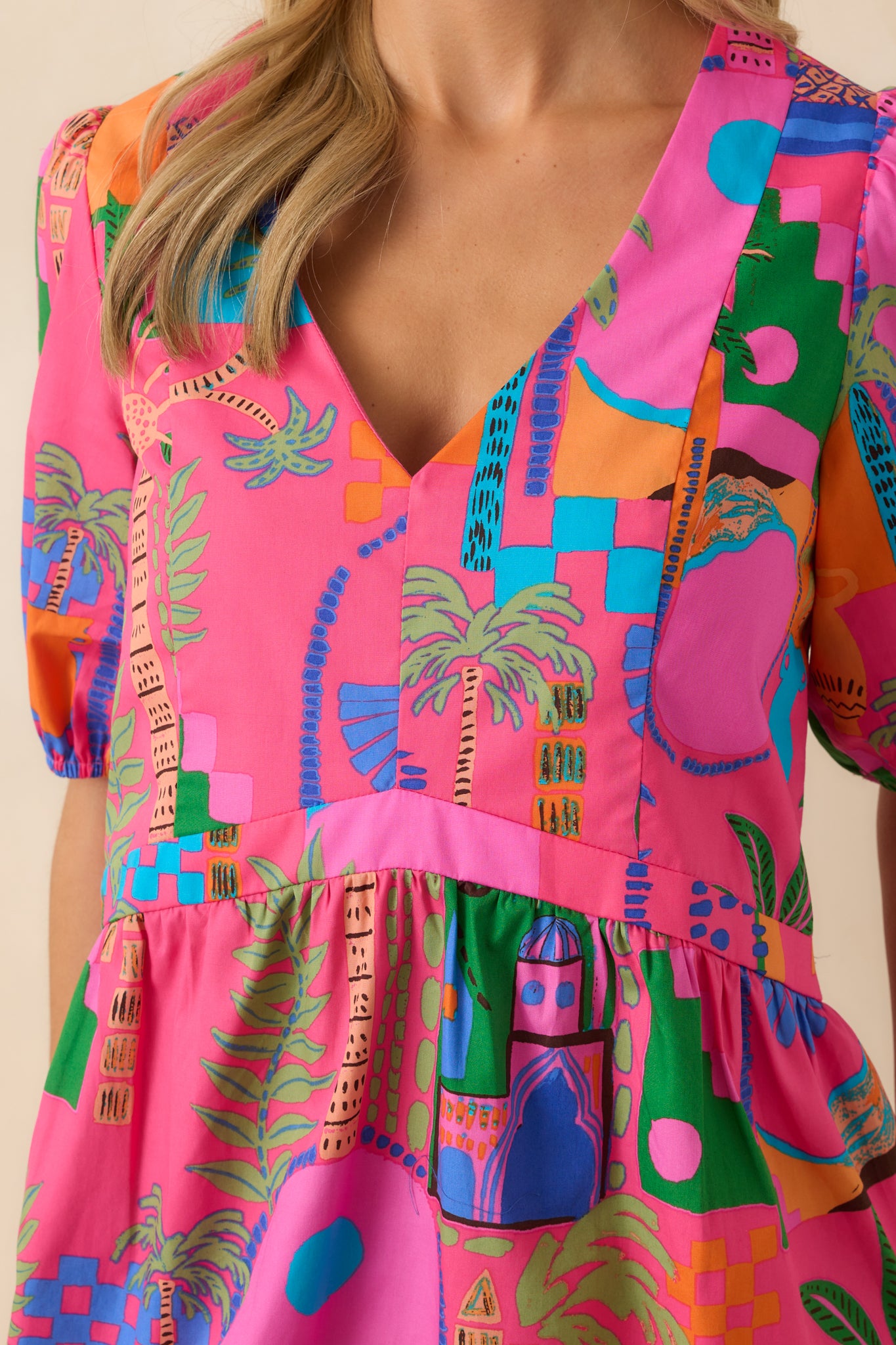 Close-up detail of the puff sleeve with elastic cuff, showing texture in the fabric and fine detail of the tropical print.