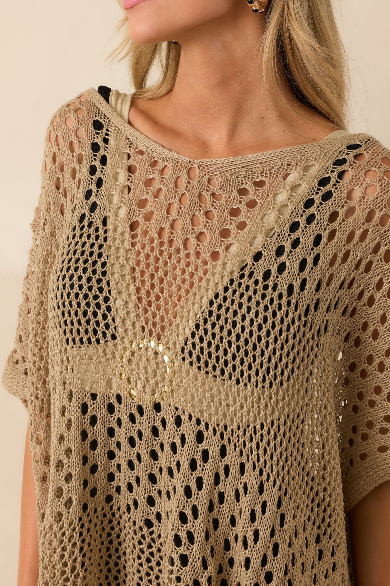 A close-up of the chunky knit texture and the neatly finished cuffed sleeve edge.