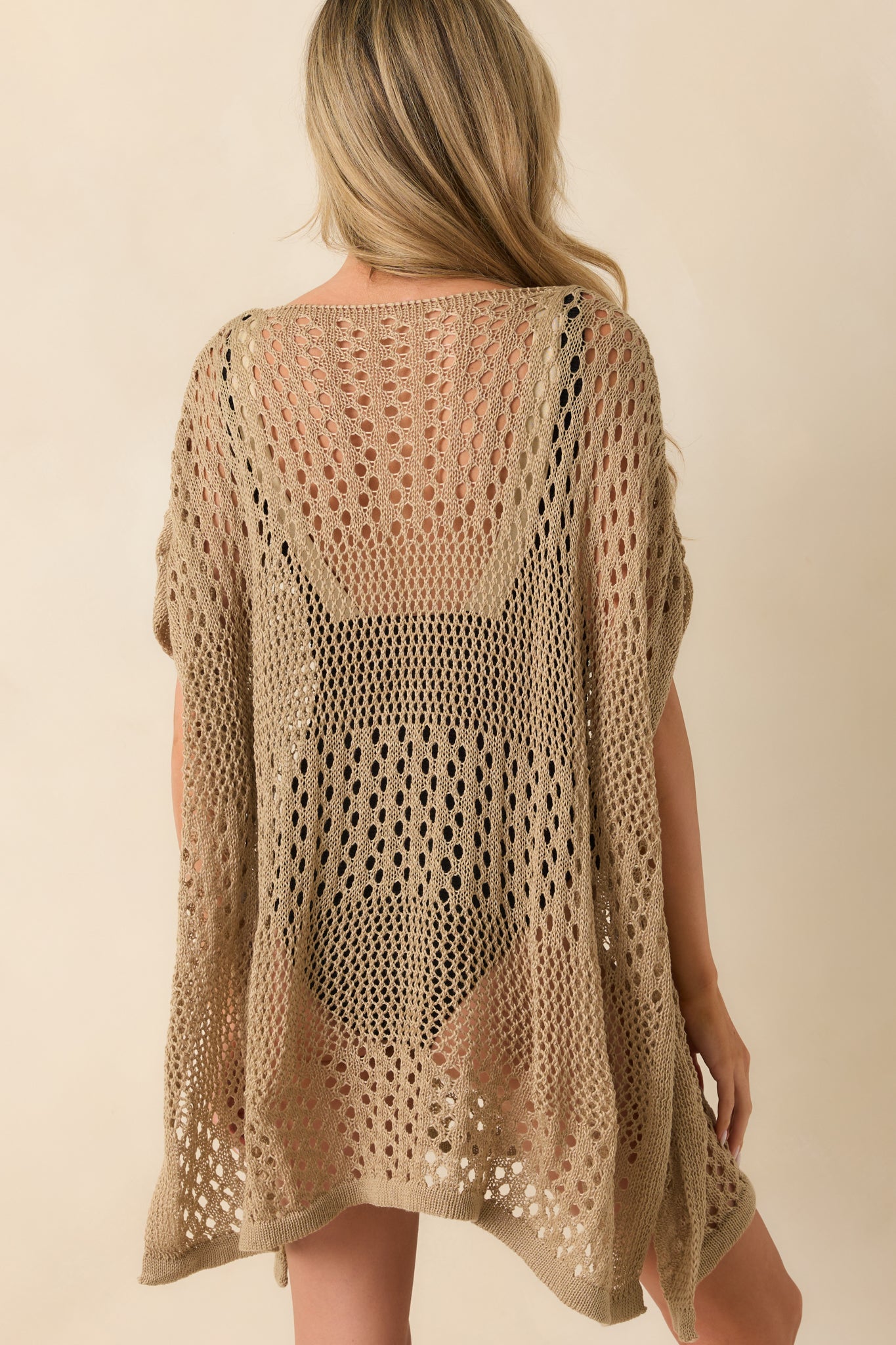 A back view displaying the continuous chunky knit material, dropped shoulder seams, and the relaxed drape of the back panel.