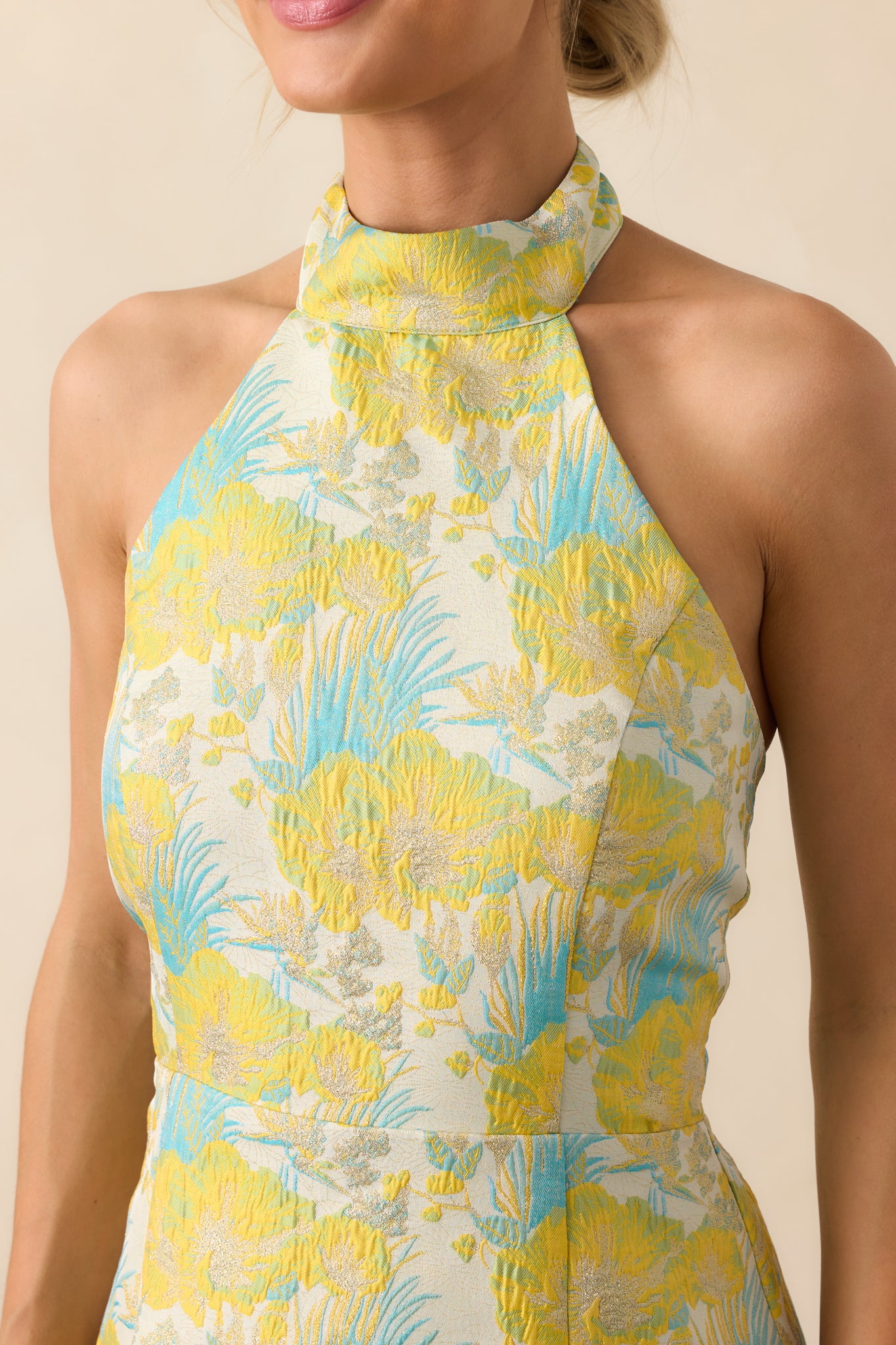 Close-up detail of the jacquard fabric showing the intricate blue palm frond pattern woven into the yellow background.