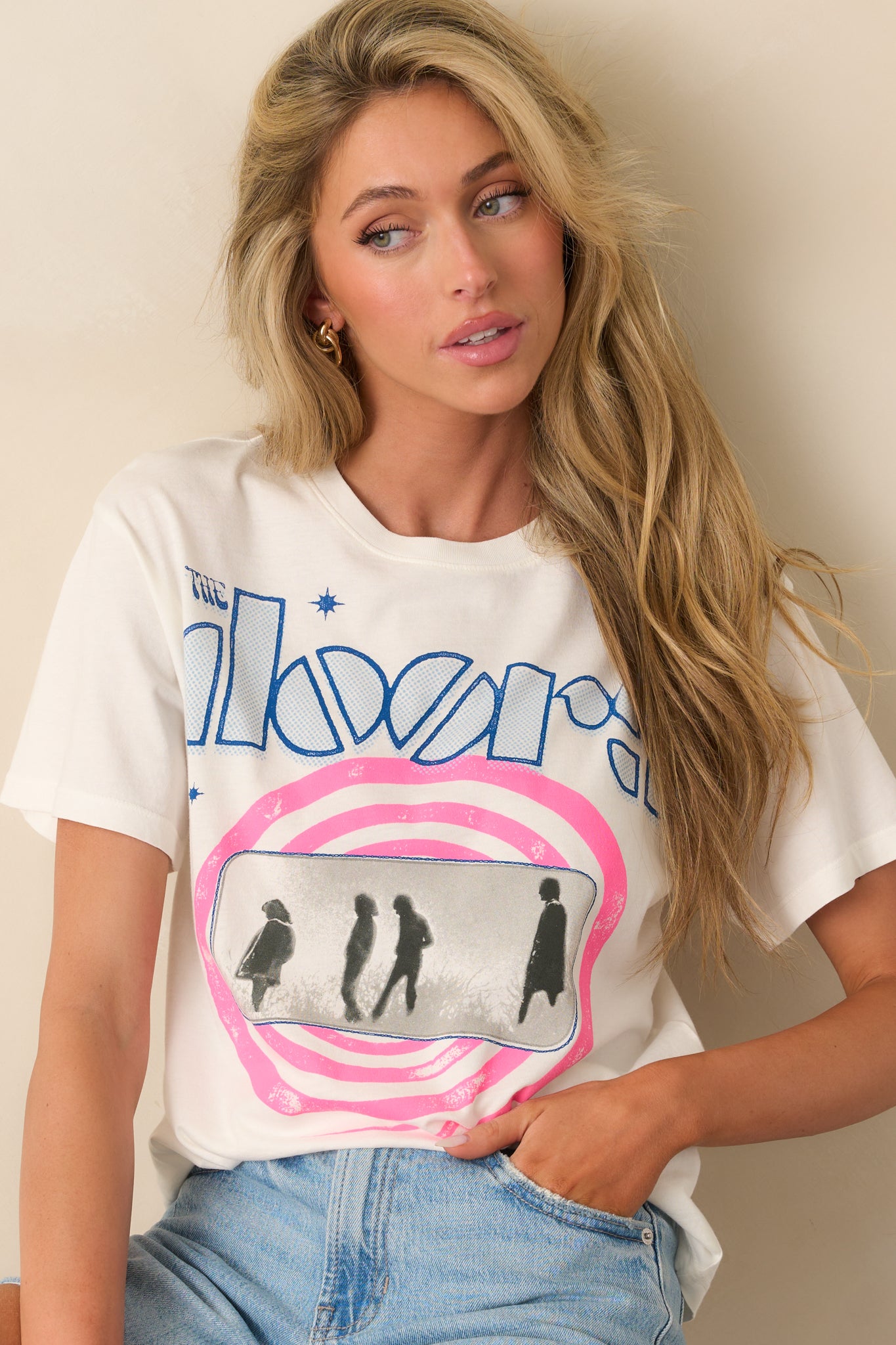 Detail of the hem and fabric drape on the white tee, showing softness and relaxed fit.