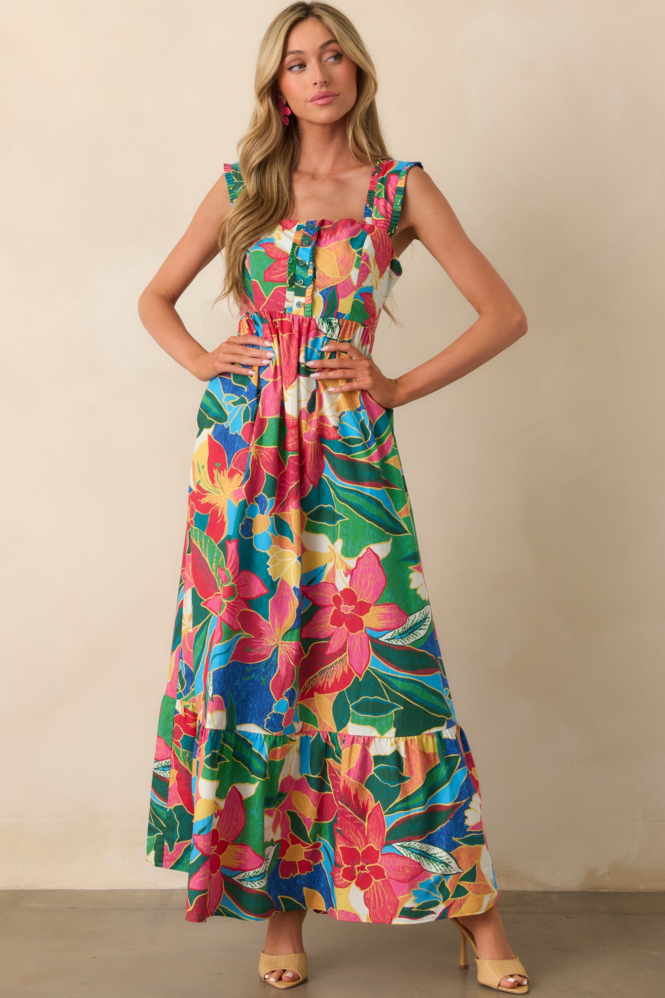 Front view of a blue maxi dress featuring a multicolor tropical floral print and square neckline.