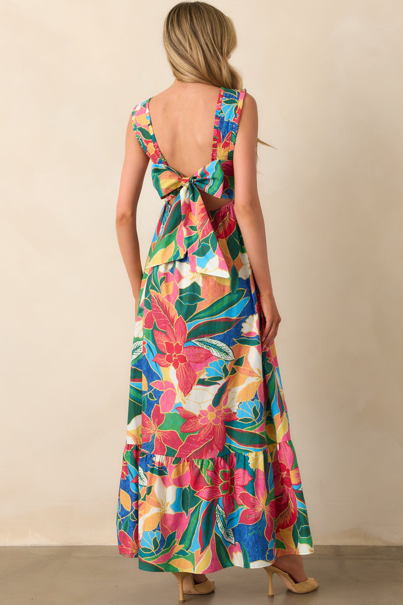 A view from behind showing the open self-tie bow back and elastic waist insert of the maxi dress.