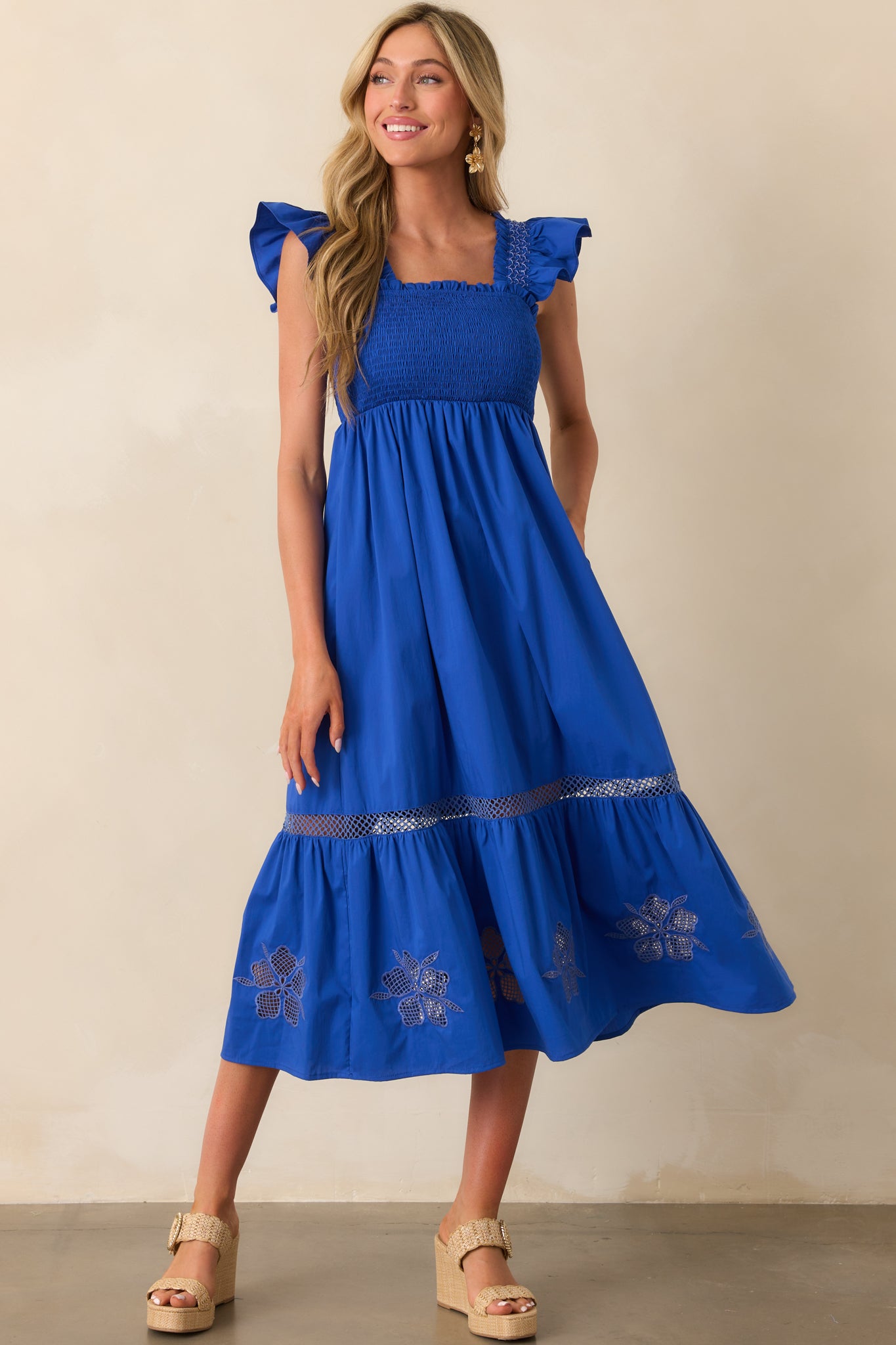 Front view of a cobalt blue midi dress with a square neckline and flutter sleeves.