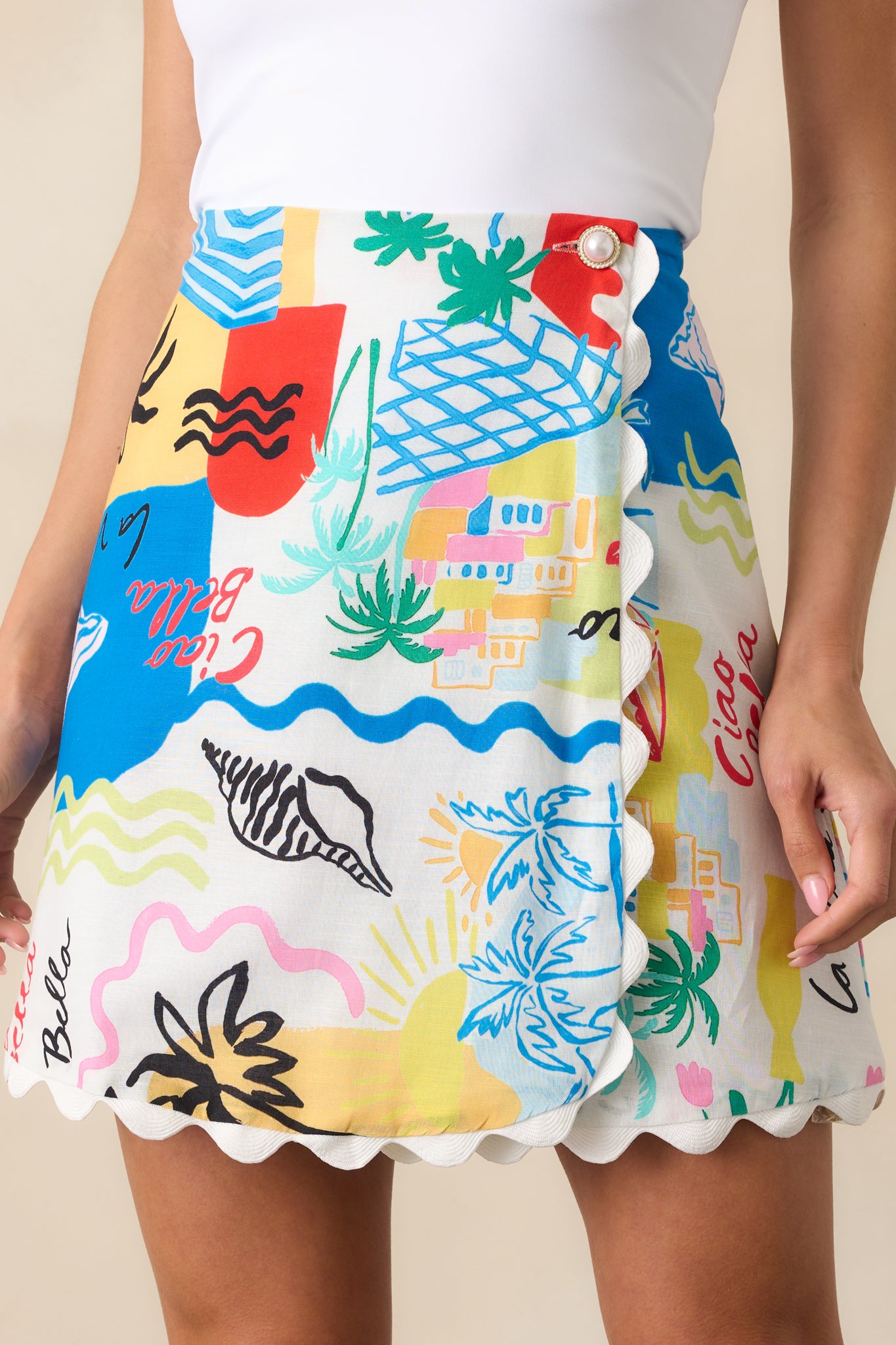 A zoomed-in shot of the tropical print fabric and scalloped hem stitching, capturing fine details and vibrant color in the pattern.