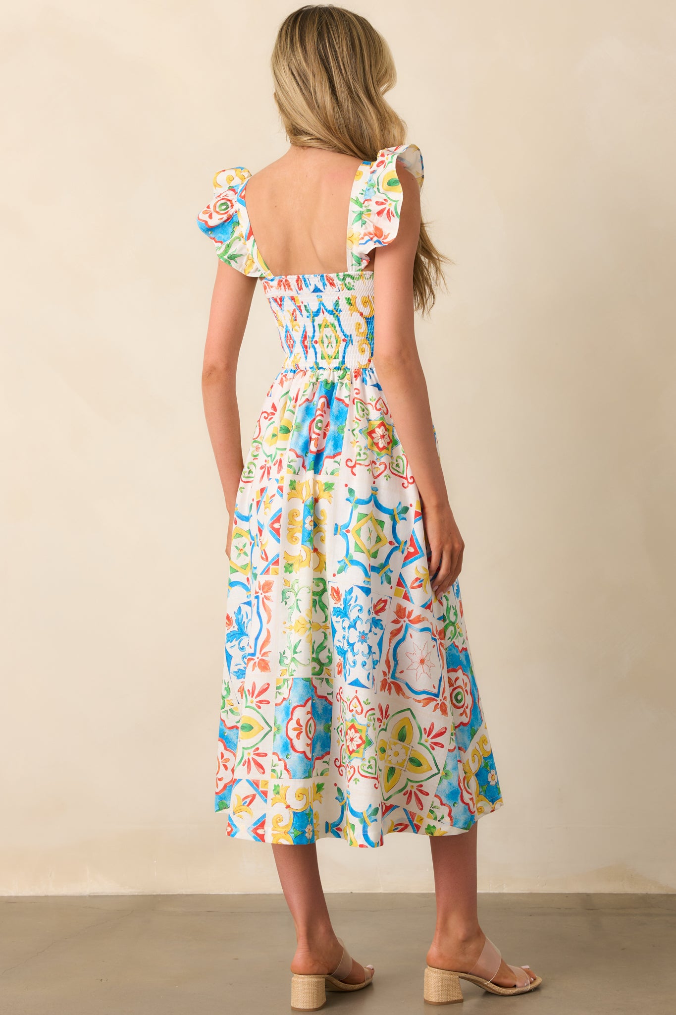 A back view of the dress, showing the smocked back panel and how the Sicilian tile design continues seamlessly across the back.