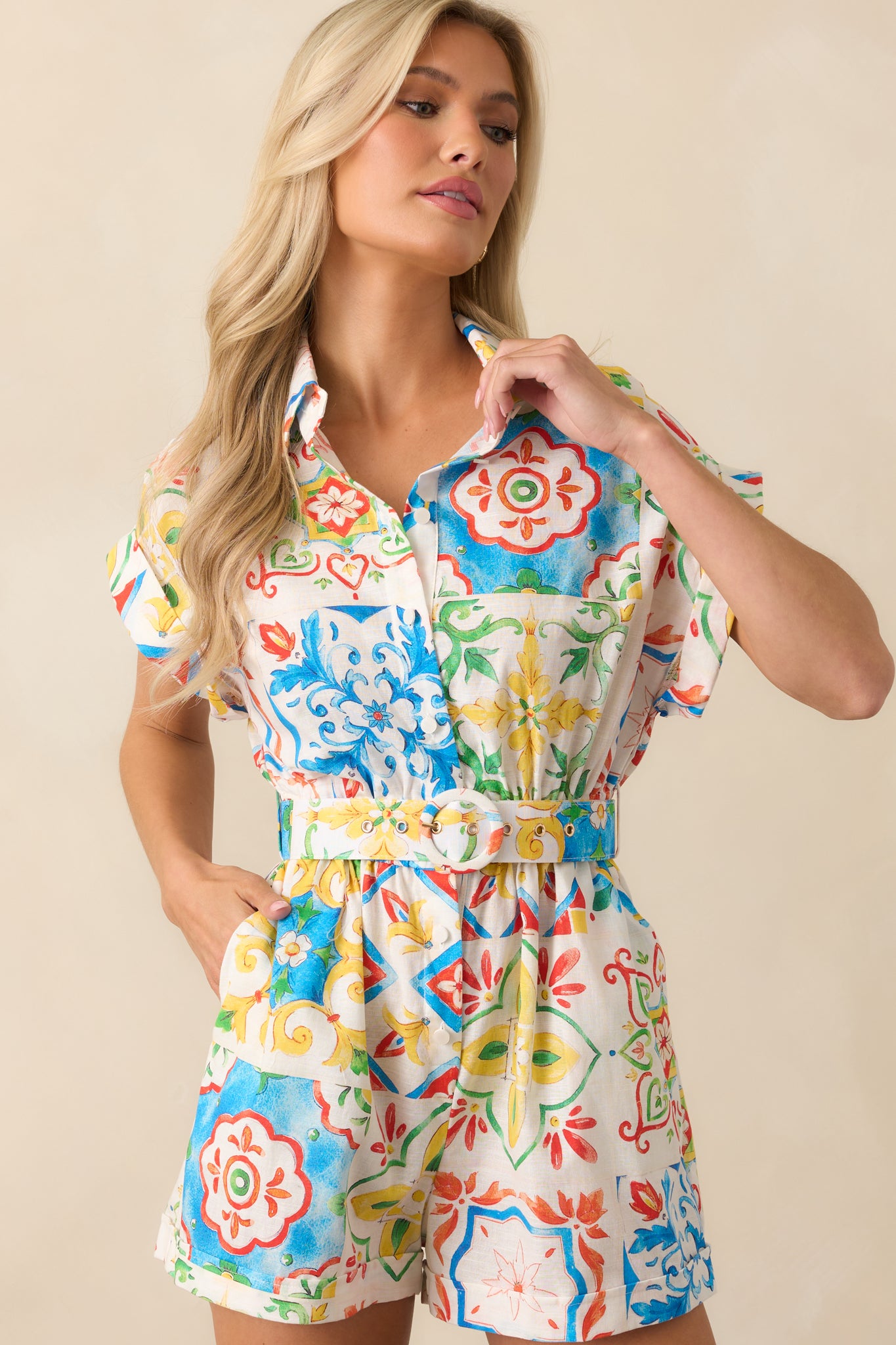 A focused view of the romper’s waistline and belt, emphasizing the elastic band, belt loops, and structured midsection.