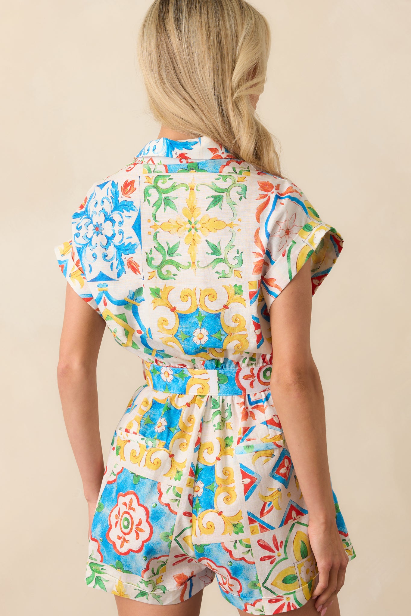 A back view of the romper showing two faux back pockets, the elastic waistband, and the continuation of the Sicilian tile design.