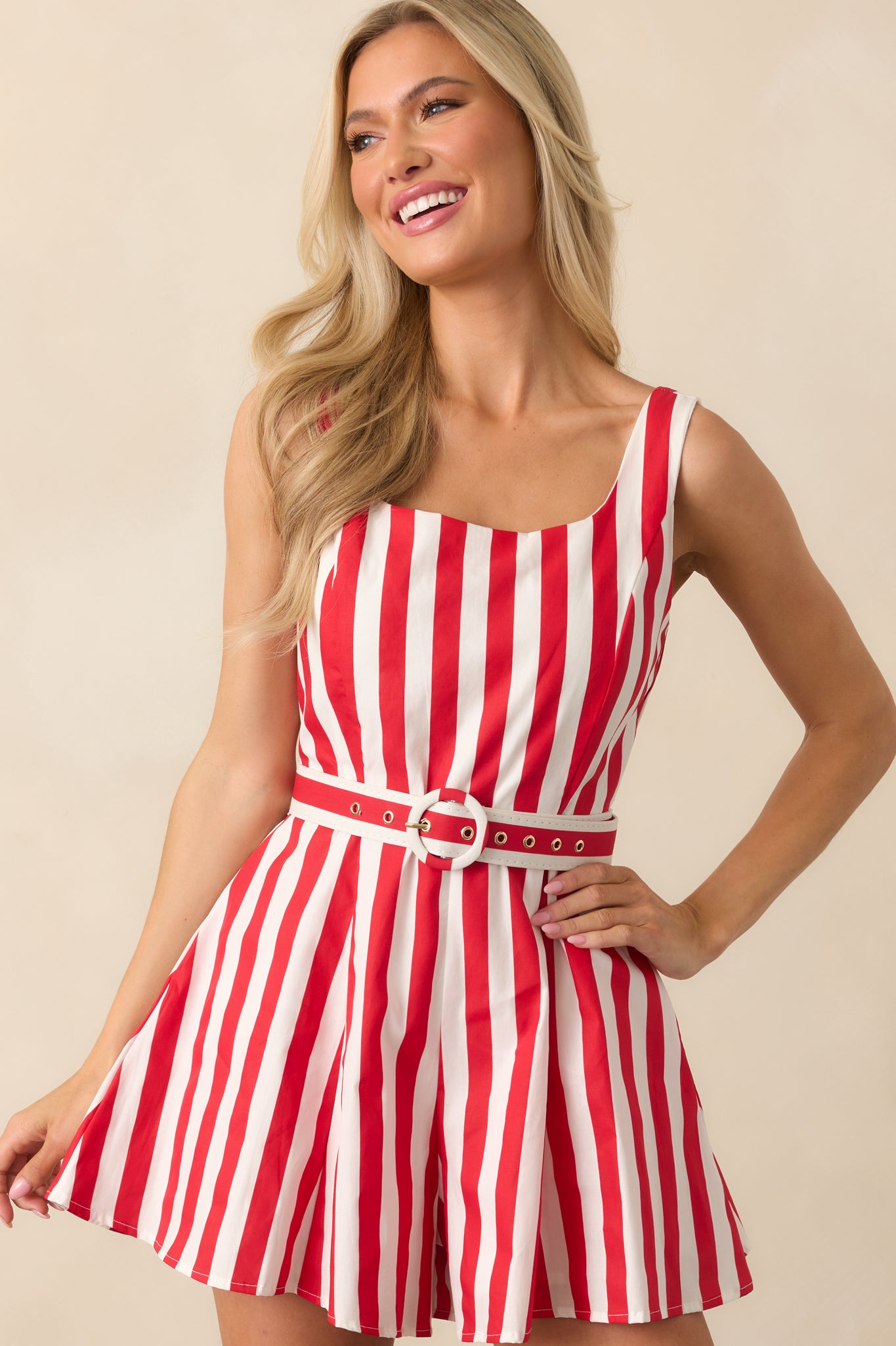 A close crop of the romper showing the squared neckline and vertical red stripes for a structured, summery look.