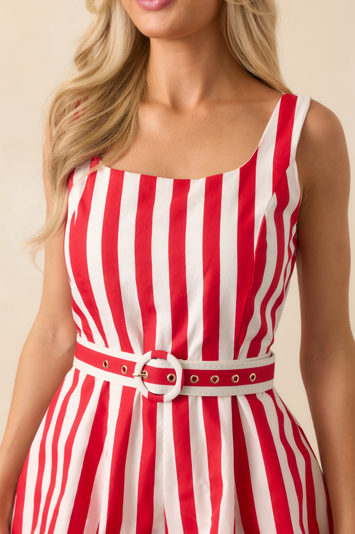 A zoomed-in shot of the fabric and belt loop, capturing the fine stripe pattern and stitching details around the waist.