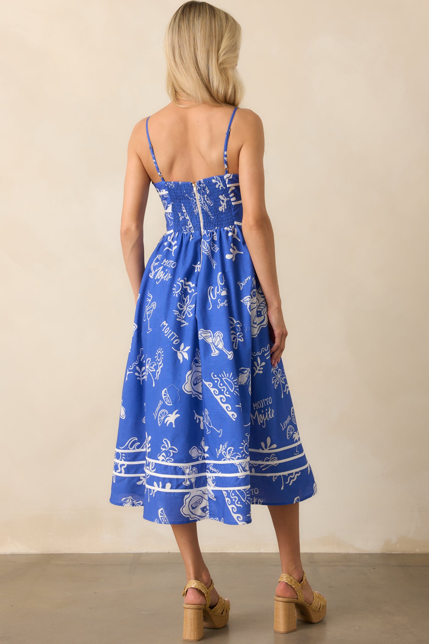 A view from behind showing the smocked panel, gold hardware zipper, and continued mojito design across the back.