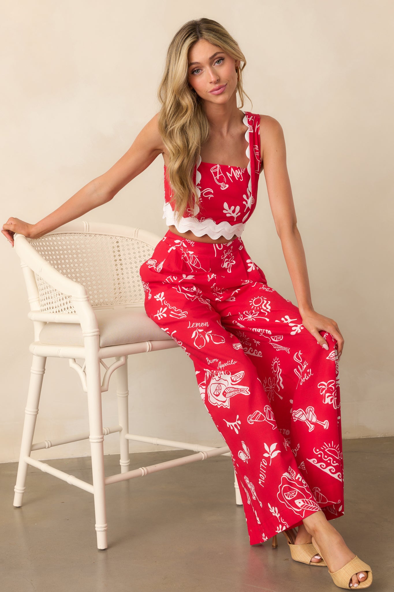 Red high waisted pants with a wide leg silhouette and two functional side pockets.