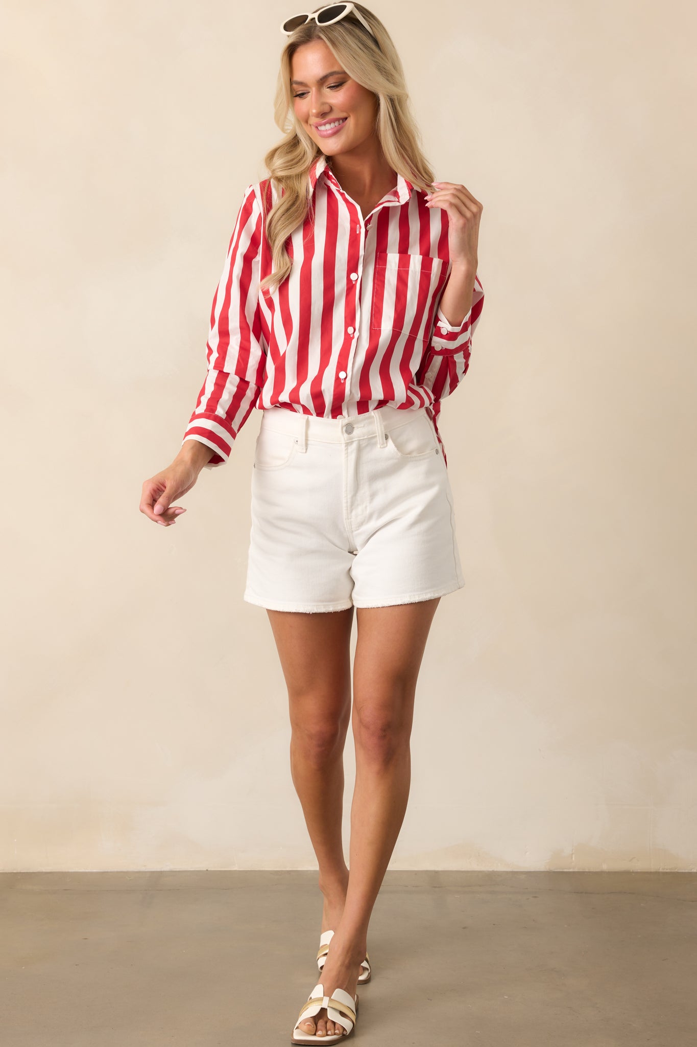 Red stripe top with a collared neckline and functional button front design for a tailored look.