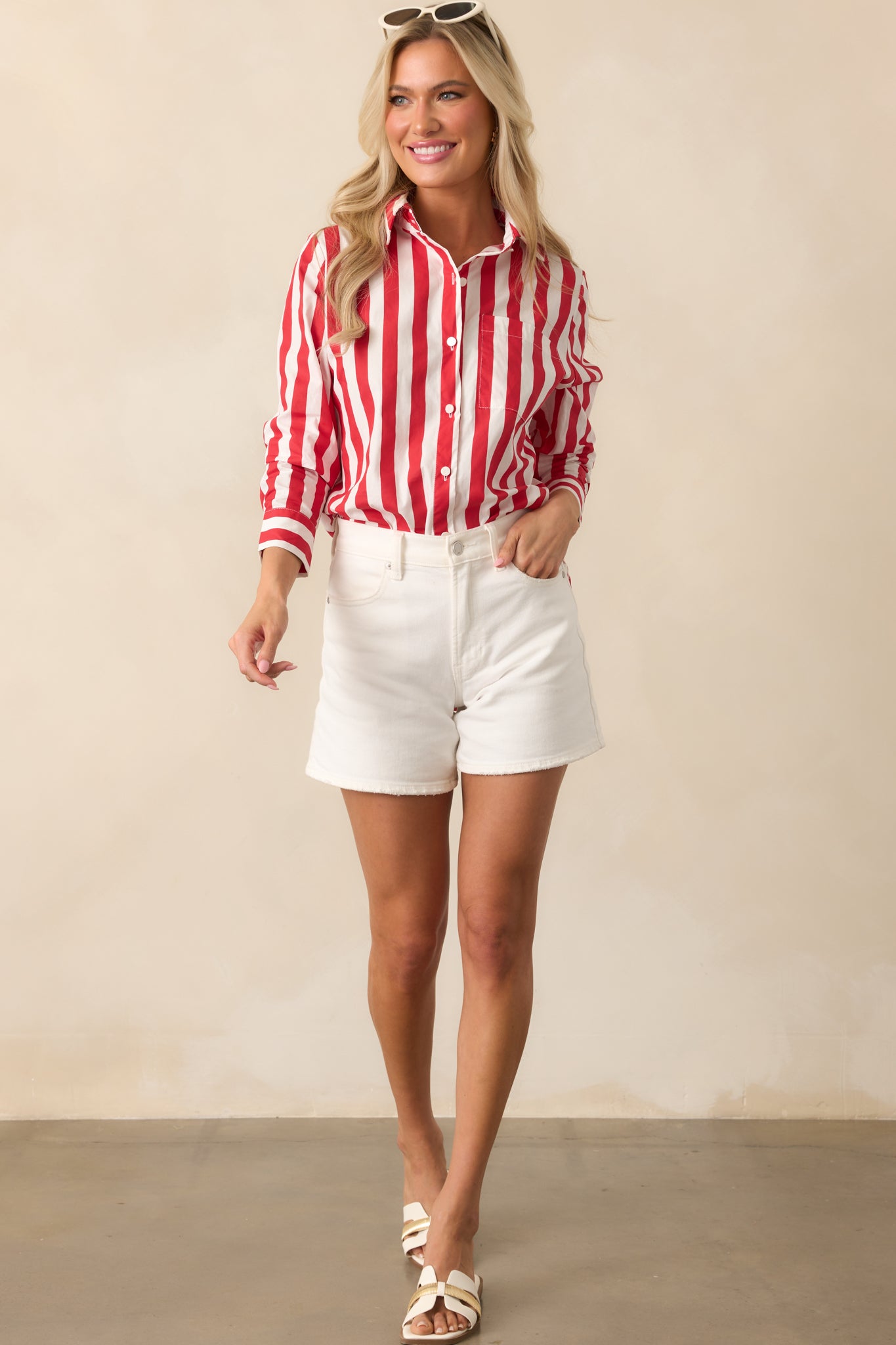 Long sleeve red striped top featuring a breast pocket and pearlescent buttons down the front placket.