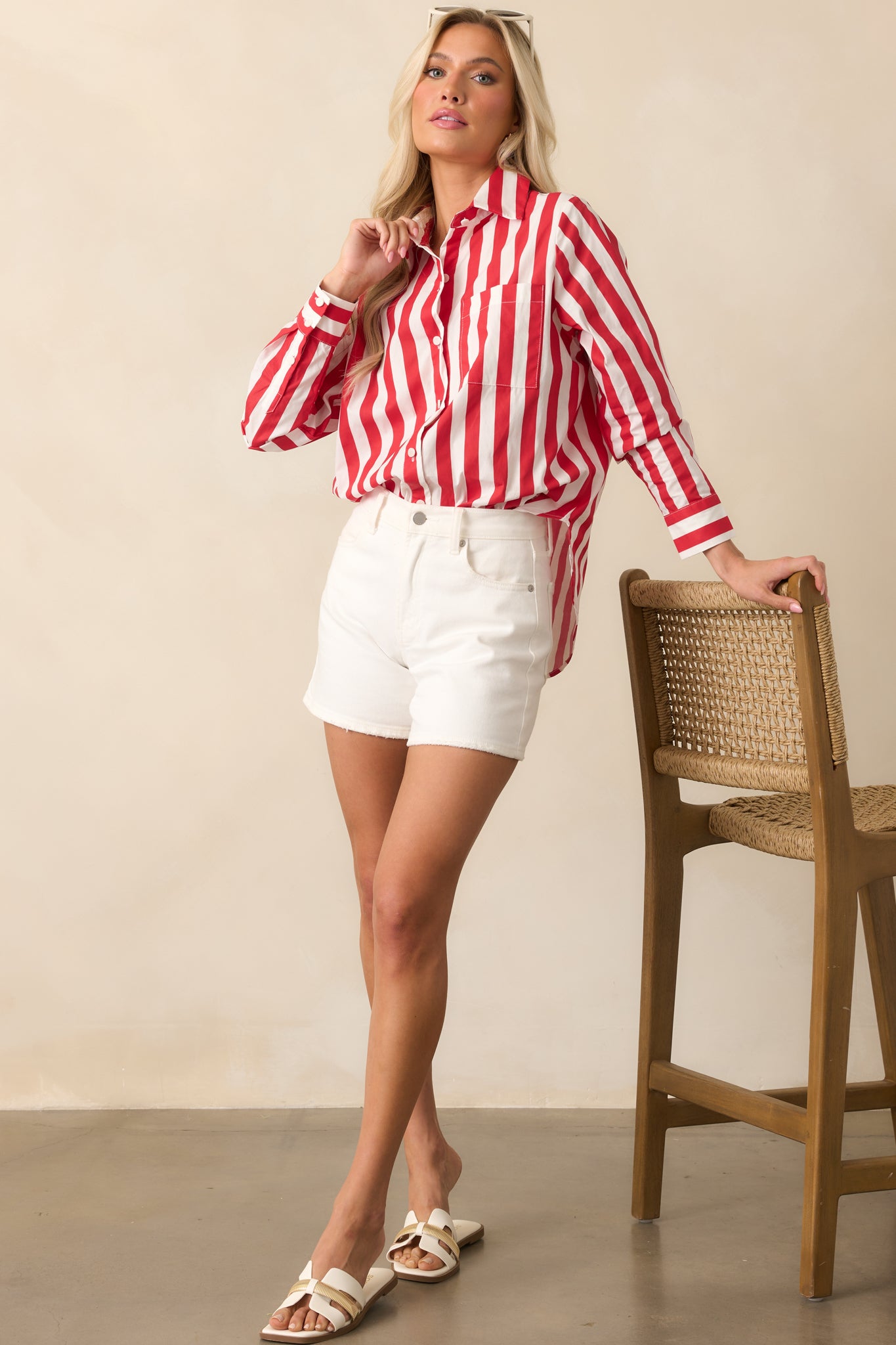 Red striped top with functional buttons and long sleeves, styled with a clean, classic silhouette.