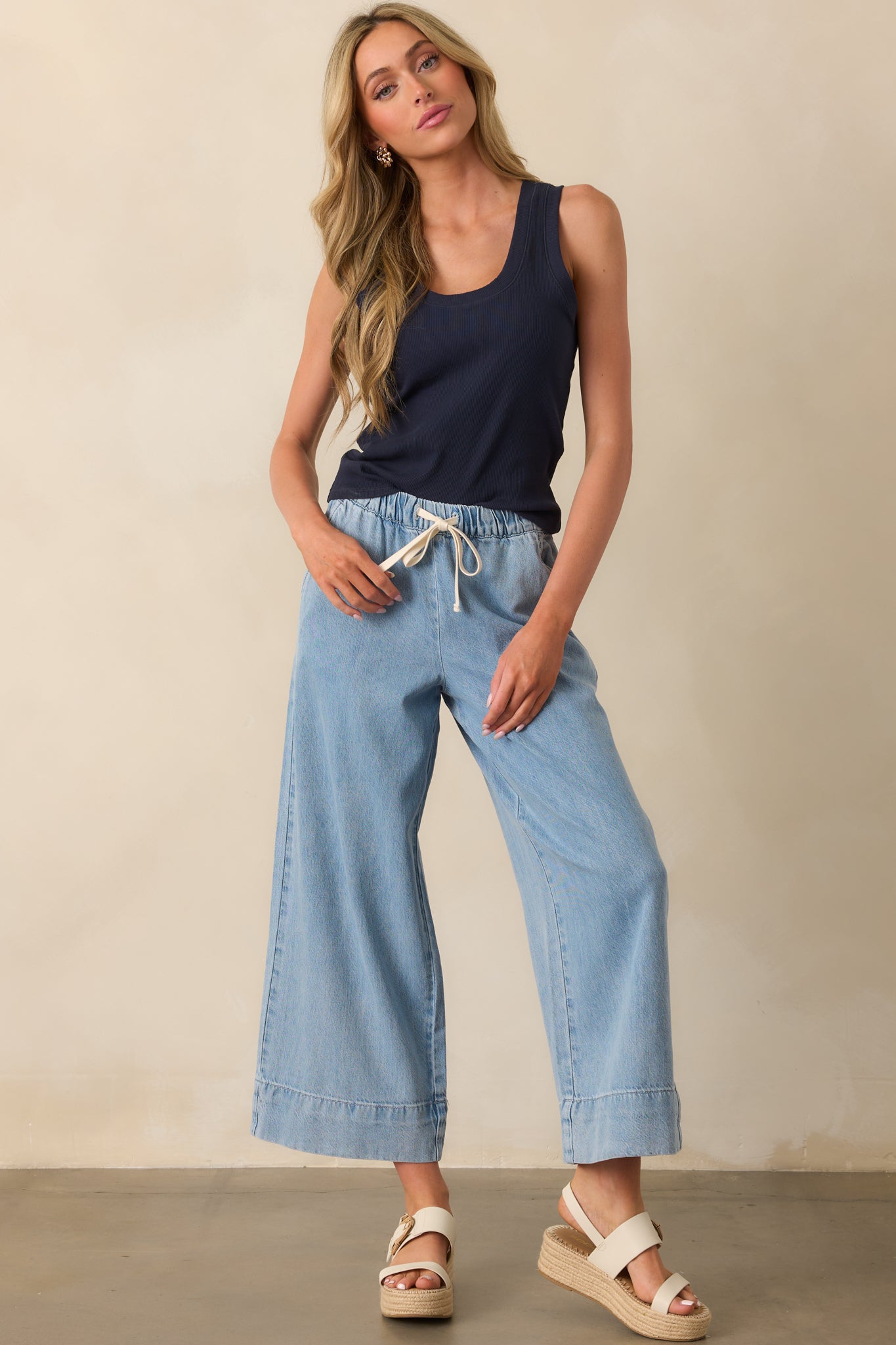 Full-length shot highlighting the elastic drawstring waist and relaxed fit of the cotton blend pants.