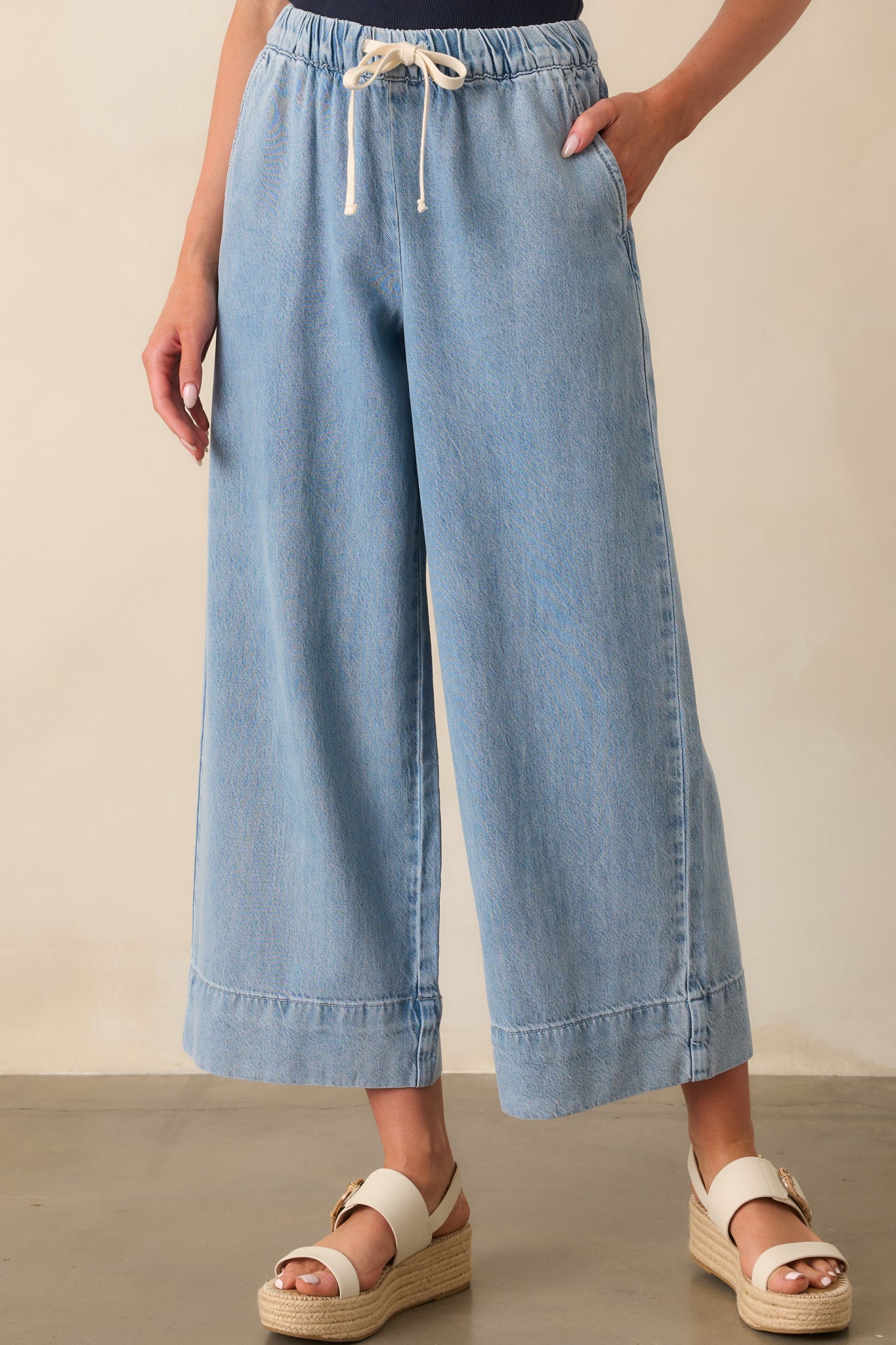 Cropped image of the waistband area, focusing on the elastic waist and drawstring tie.