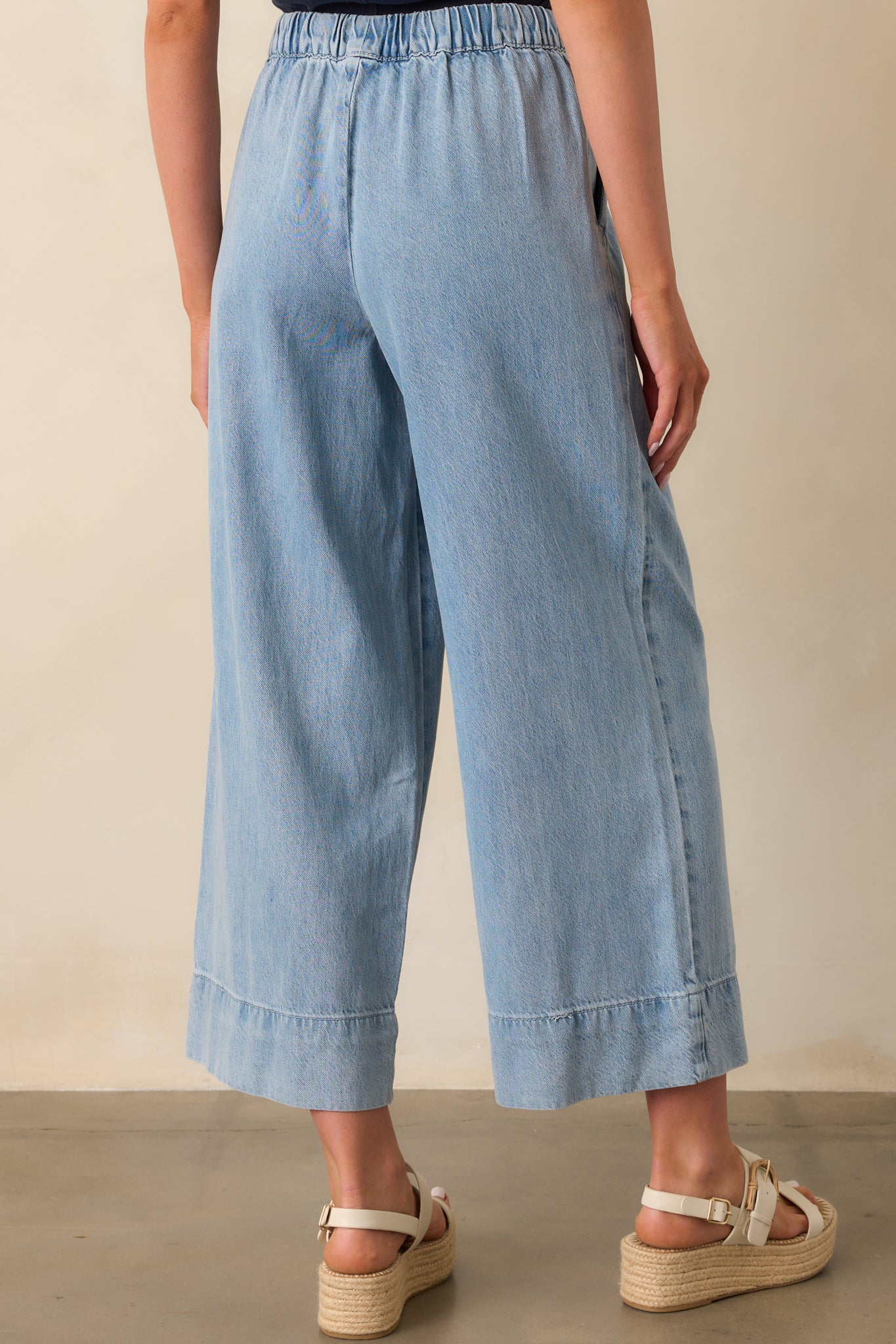 Rear view of the pants, showing the wide leg shape and the relaxed fit from the back.