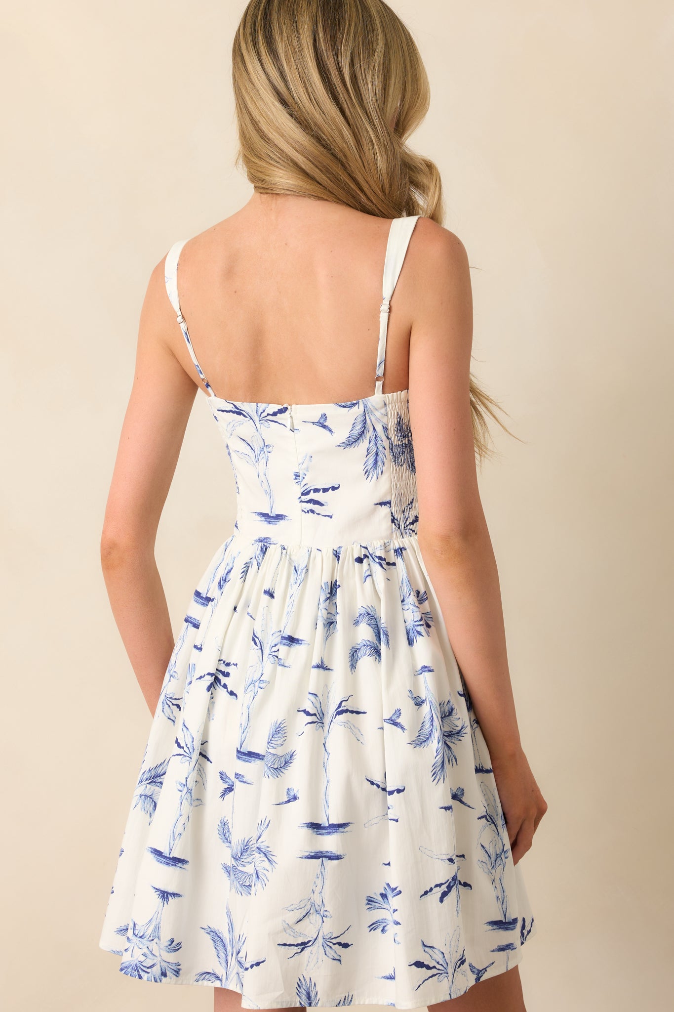 A view from behind showing the hidden zipper closure and continuation of the palm print across the skirt.