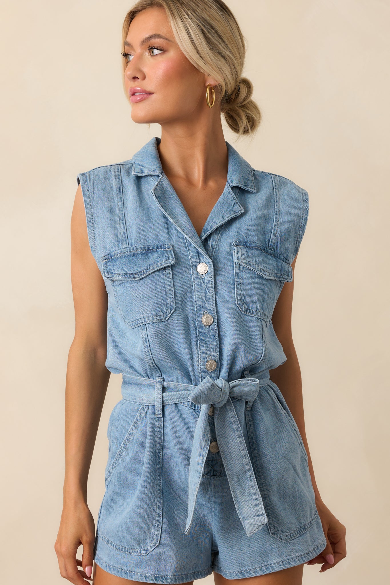 Midsection of the romper focusing on the adjustable self-tie belt and subtle seaming details at the waist.