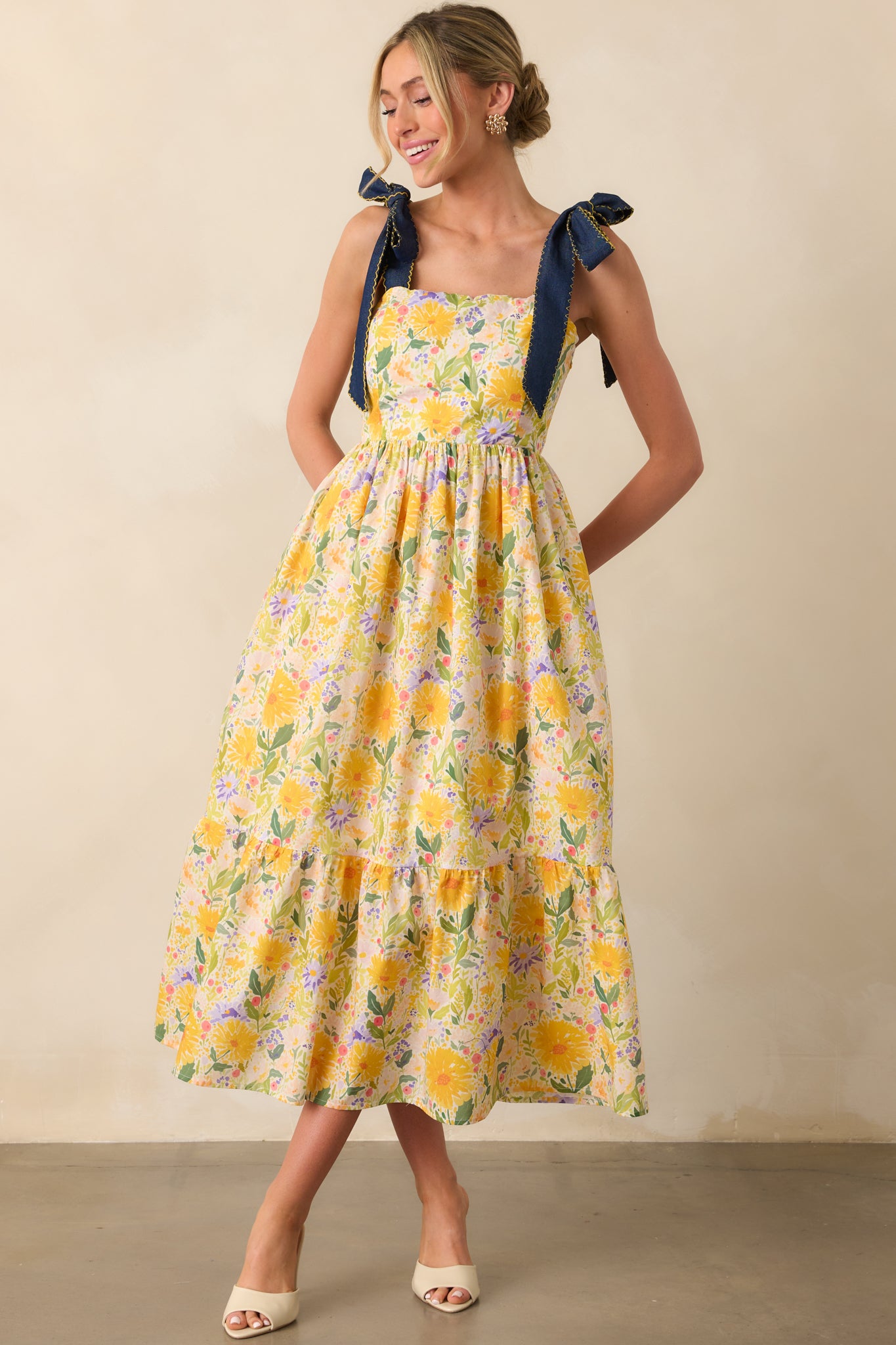 Maxi dress featuring vibrant floral pattern and bow straps tied at the shoulders.