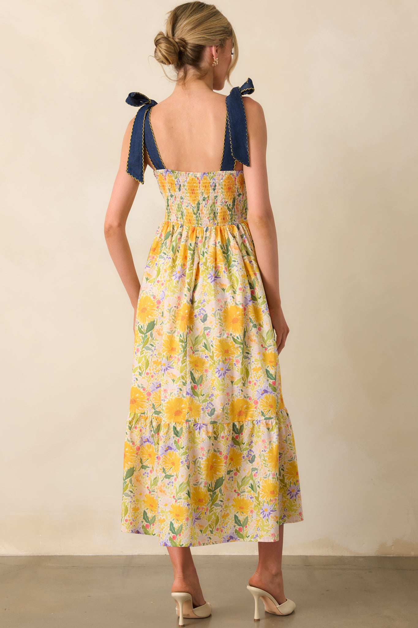 View from behind showing the smocked back panel and continuation of the floral print across the dress.