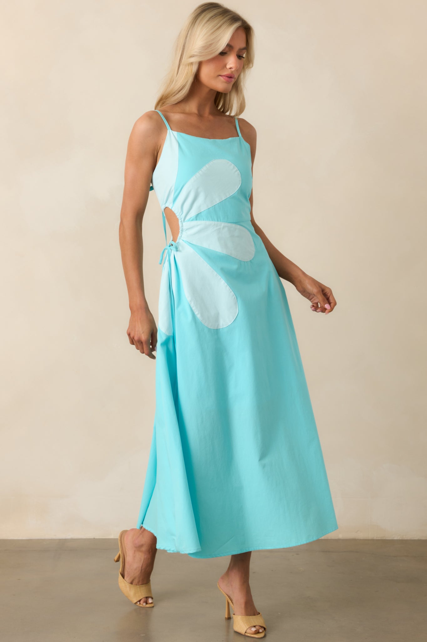 Front-facing shot emphasizing the side waist cut-out detail and smooth fit of the maxi dress.